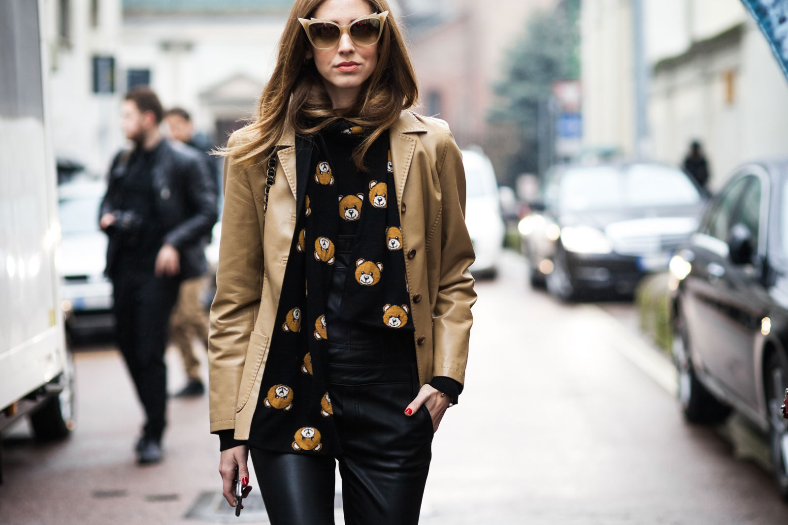 Chiara Ferragni wearing a vintage leather jacket, Moschino bear-print sweater and scarf, Black Orchid leather overalls, Céline shoes, Dita Eyewear sunglasses and Prada backpack before the Dsquared2 Fall/Winter 2015-2016 fashion show in Milan, Italy