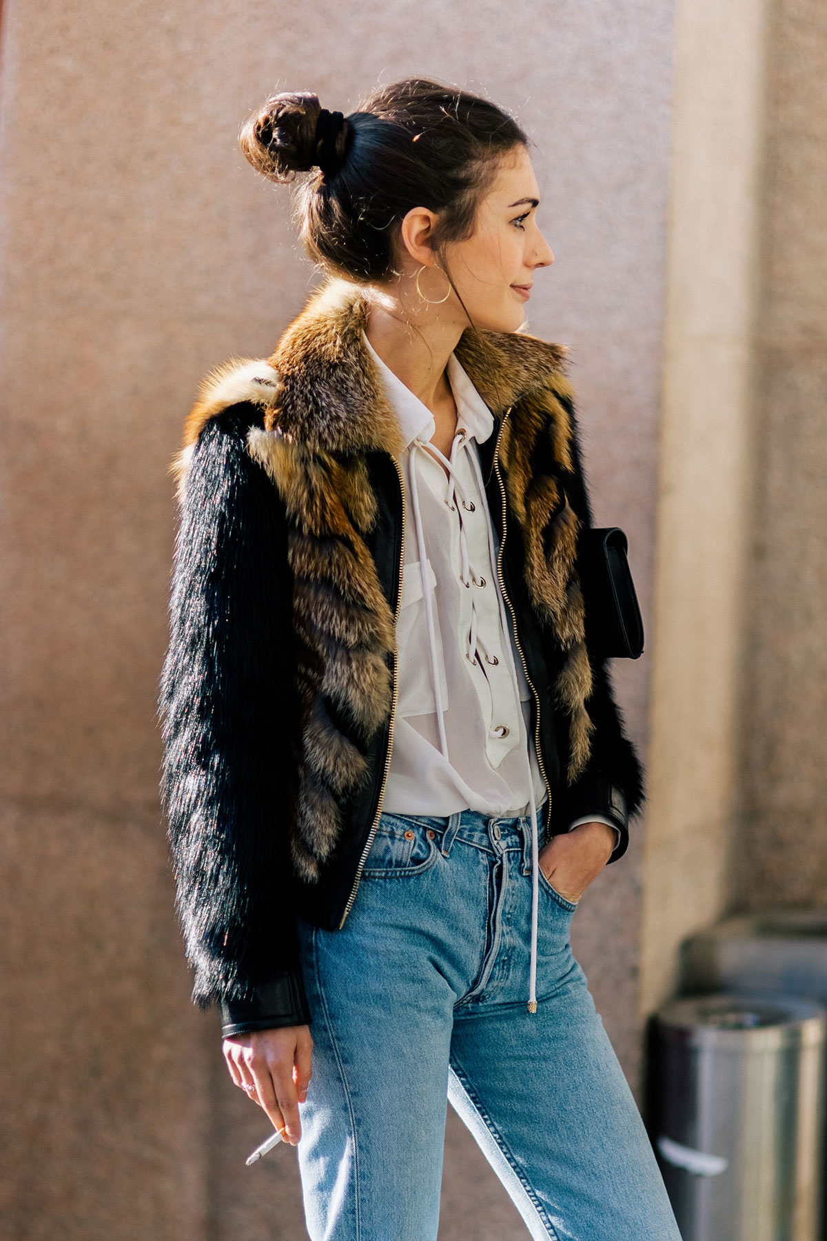 Diletta Bonaiuti wearing a Roberto Cavalli fur jacket and Levis jeans after the Fendi Fall/Winter 2015-2016 fashion show in Milan, Italy