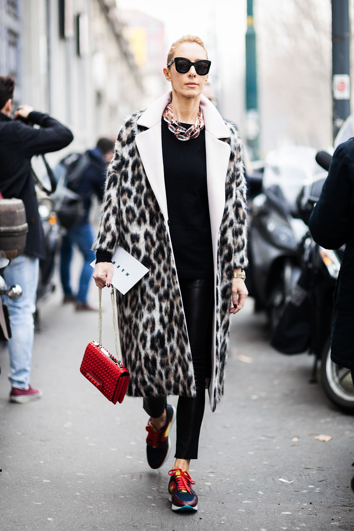 Elina Halimi wearing a MSGM leopard print coat, black leather pants, Burberry Prorsum sneakers and a Valentino studded bag after the Marni Fall/Winter 2015-2016 fashion show in Milan, Italy