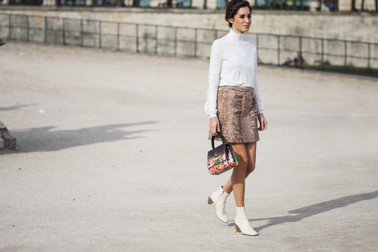 Gala Gonzalez wearing Elie Saab top, skirt ang bag and white Valentino ankle boots before the Elie Saab Fall/Winter 2015-2016 fashion show at the Tuileries in Paris, France 