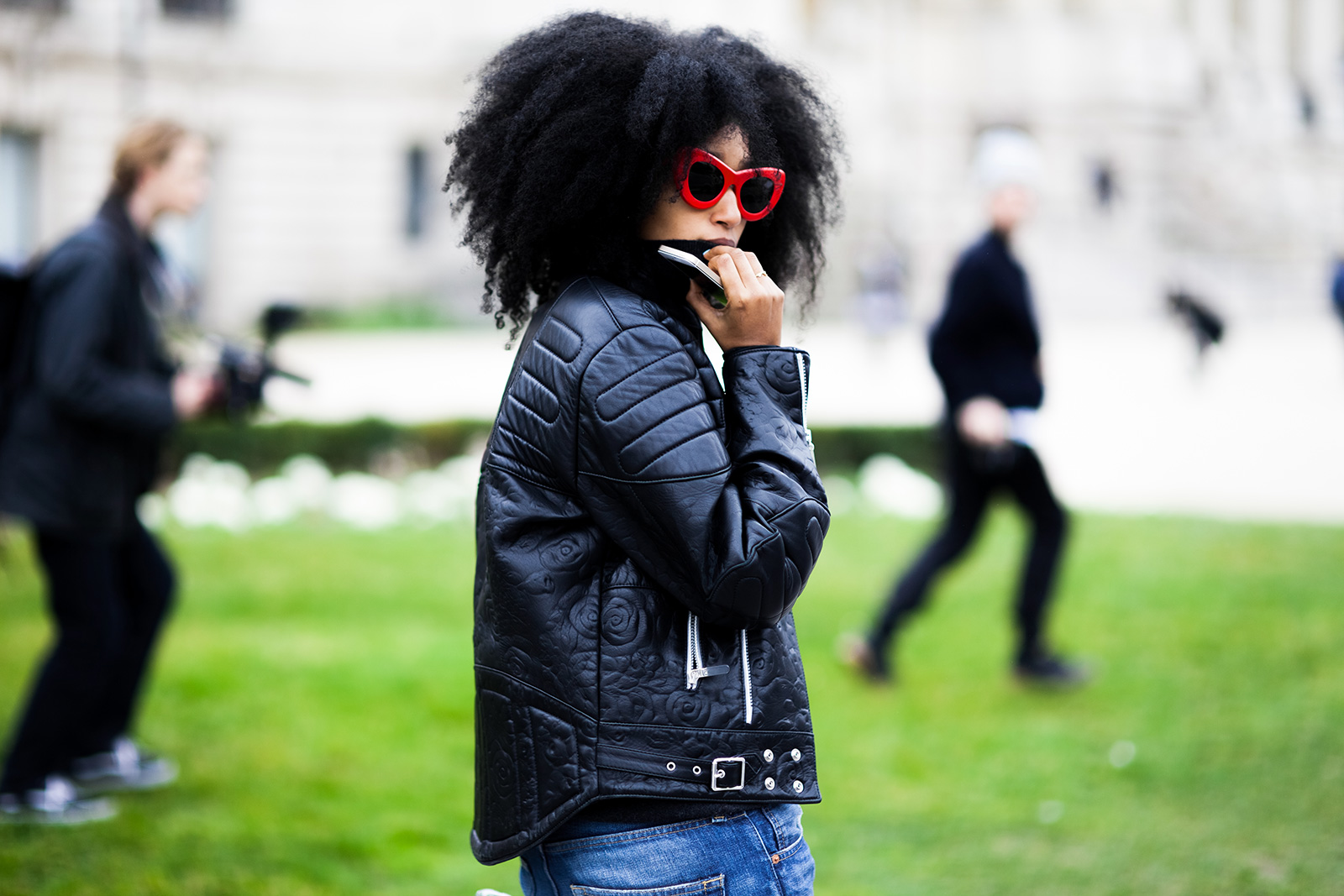 Julia Sarr-Jamois wearing a black leather jacket and red Celine sunglasses before the Chanel Fall 2015 fashion show at Grand Palais in Paris, France