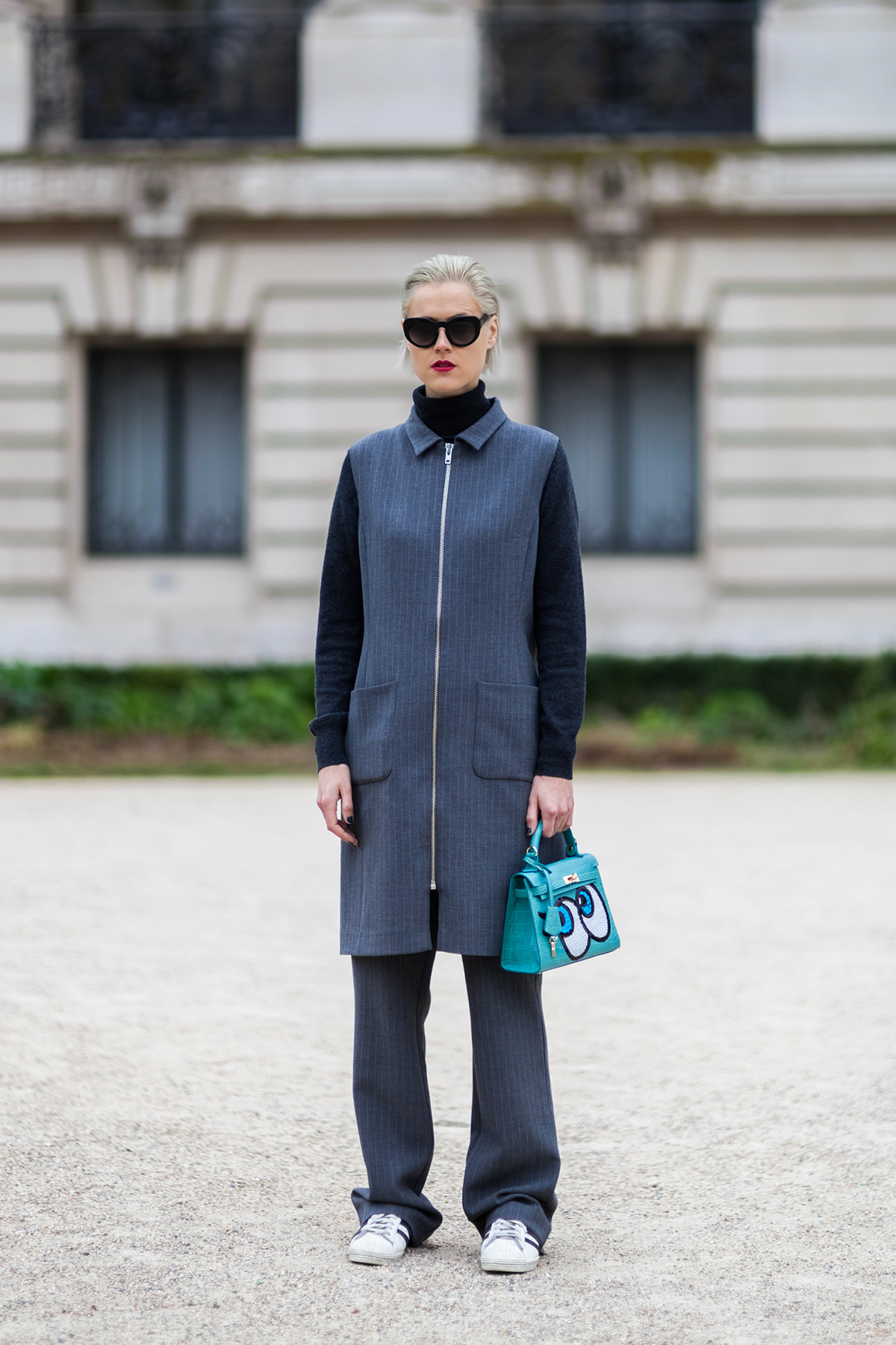 Linda Tol wearing a Ganni suit, Play no More bag and Adidas superstar sneakers before the Chanel Fall/Winter 2015-2016 fashion show at the Grand Palais in Paris, France