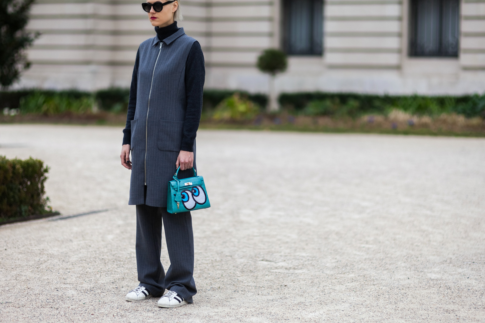 Linda Tol wearing a Ganni suit, Play no More bag and Adidas superstar sneakers before the Chanel Fall/Winter 2015-2016 fashion show at the Grand Palais in Paris, France