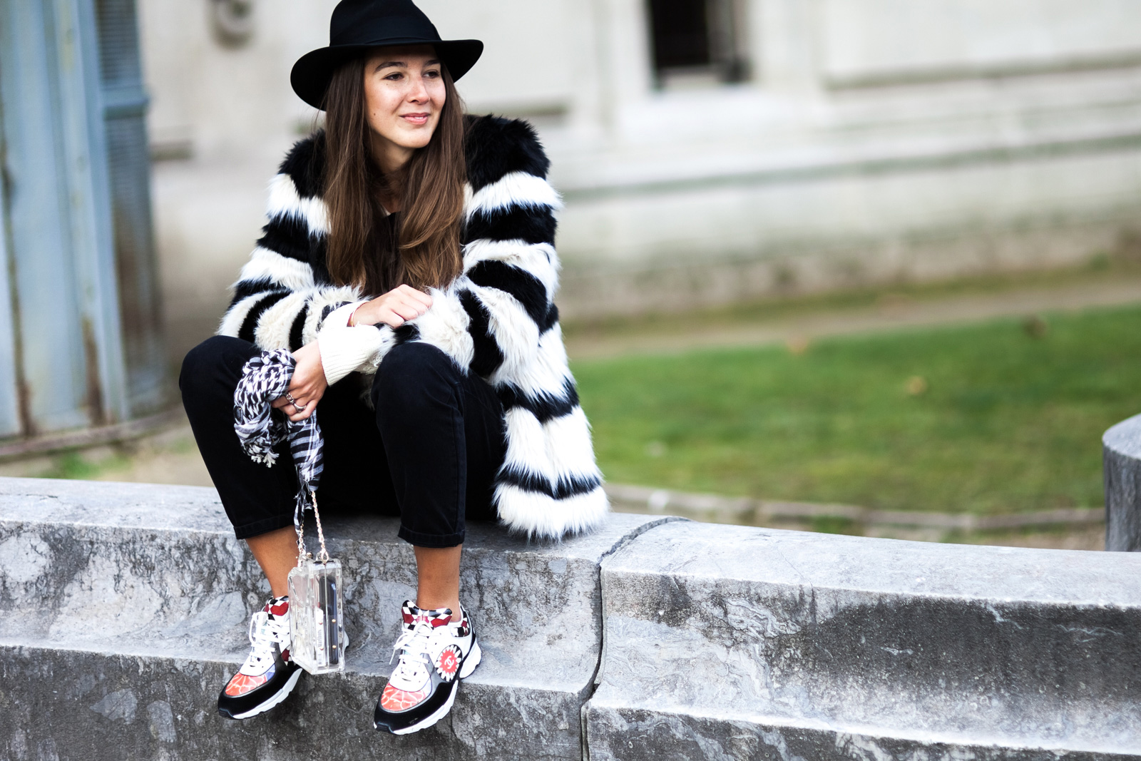 Estelle Pigault wearing Chanel sneakers and bag, Bershka fur coat, Pull and Bear sweater and Levis jeans before the Chanel Spring 2015 Haute Couture fashion show in Paris, France