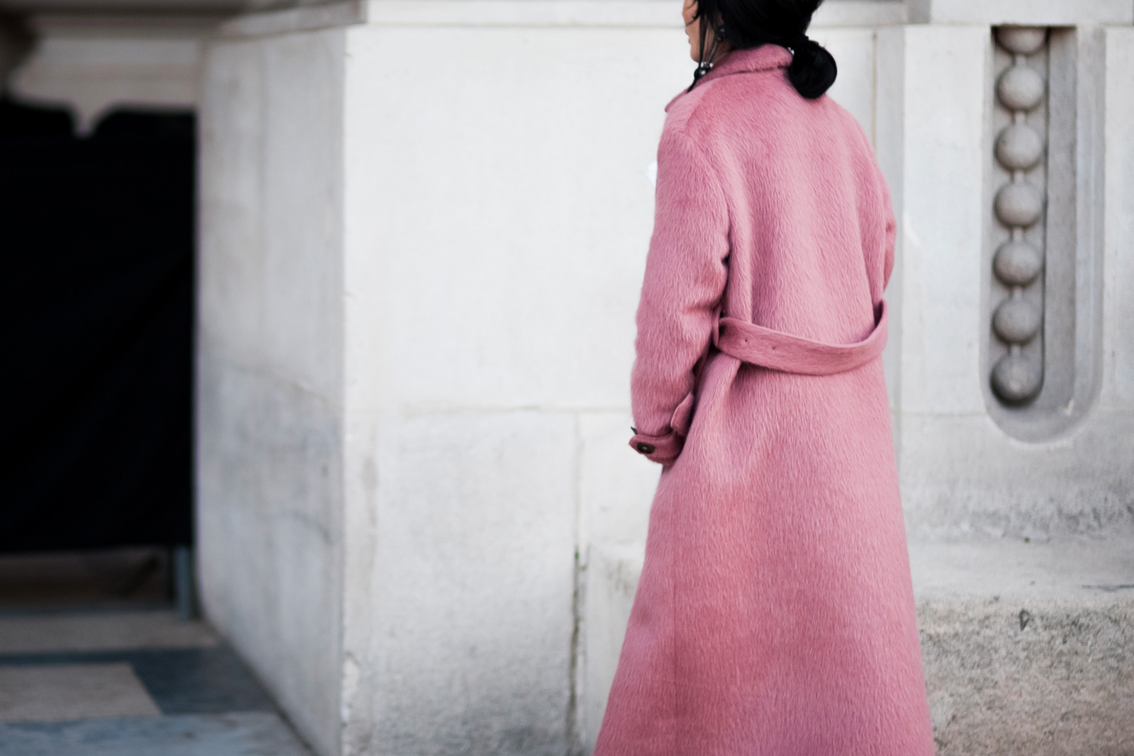 Woman wearing a pink coat before the Maison Margiela Fall/Winter 2015-2016 fashion show in Paris, France