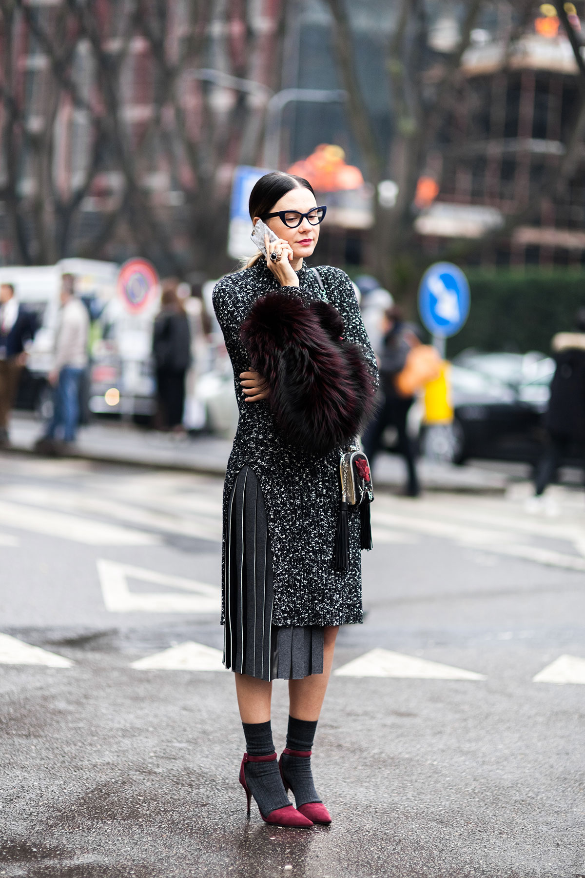 Woman wearing pleated skirt, heels and socks after the Armani Fall/Winter 2015-2016 fashion show in Milan, Italy
