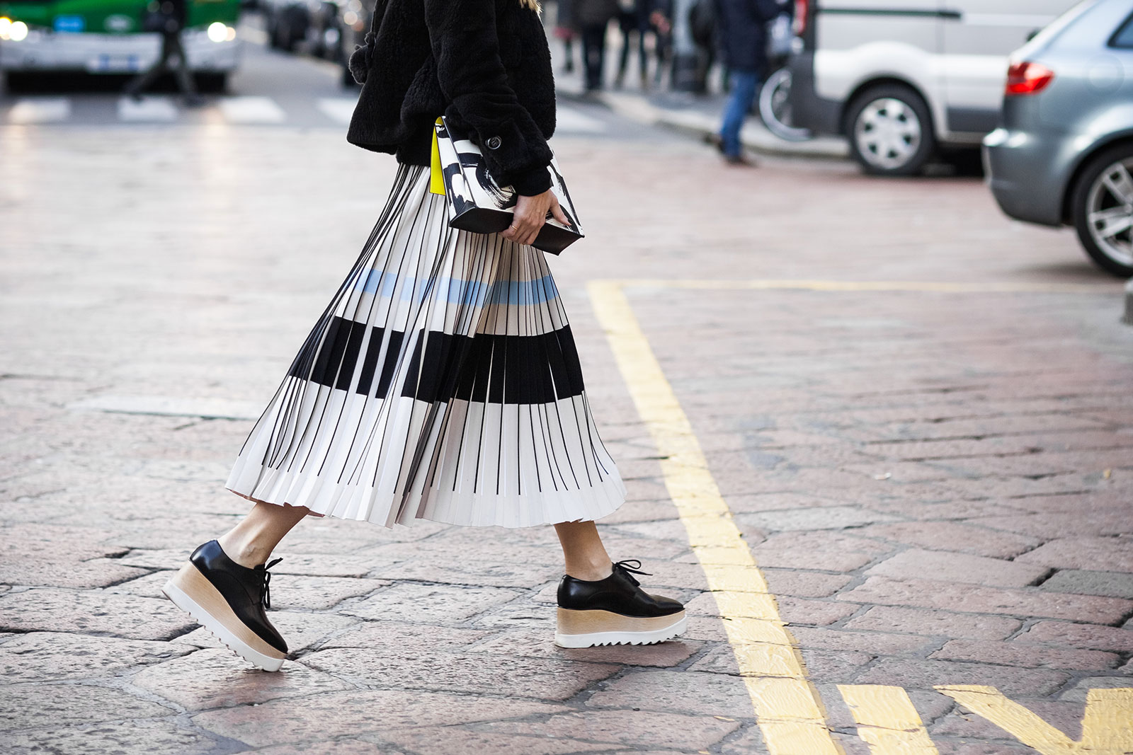 Woman wearing pleated skirt and Stella McCartney wedges before the Philosophy Fall/Winter 2015-2016 fashion show in Milan, Italy