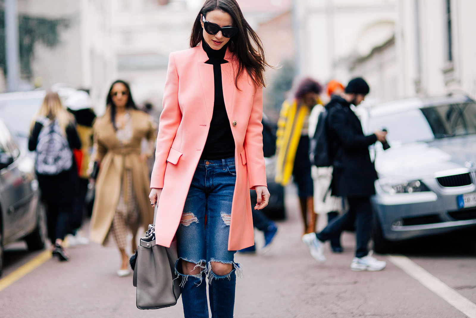 Zina Charkoplia wearing ripped jeans and pink Emilio Pucci coat in Milan, Italy