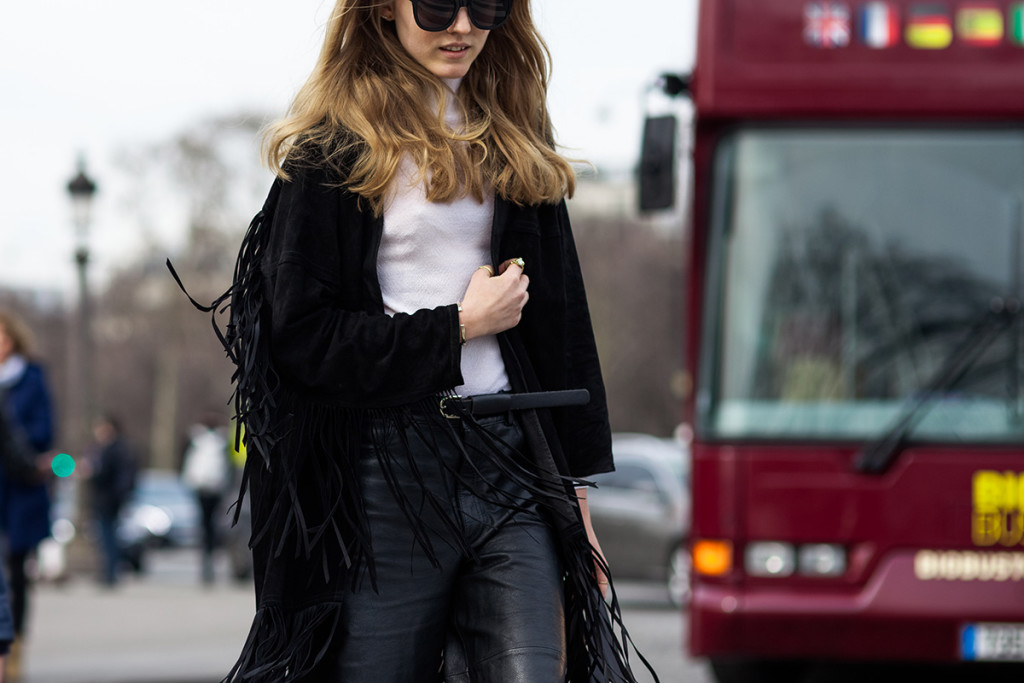 Alexandra Carl wearing a fringed jacket and leather pants in Paris, France