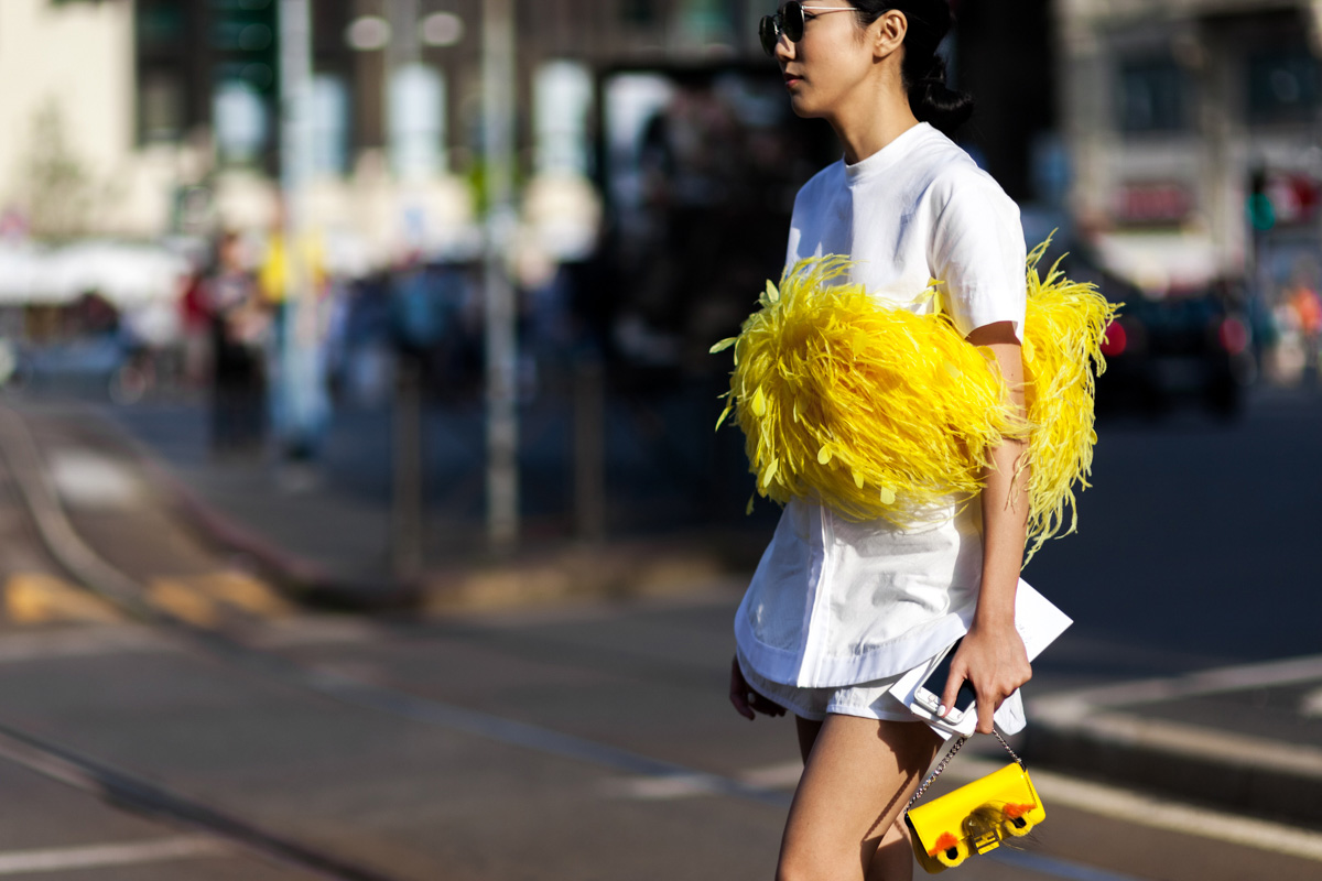 Yoyo Cao wearing a yellow feather top before a show in Milan, Italy