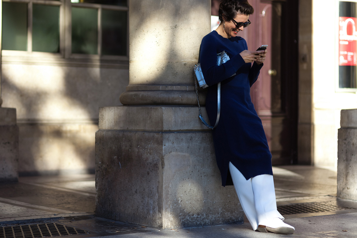 Garance Dore wearing a long sweater and white pants after a show in Paris, France