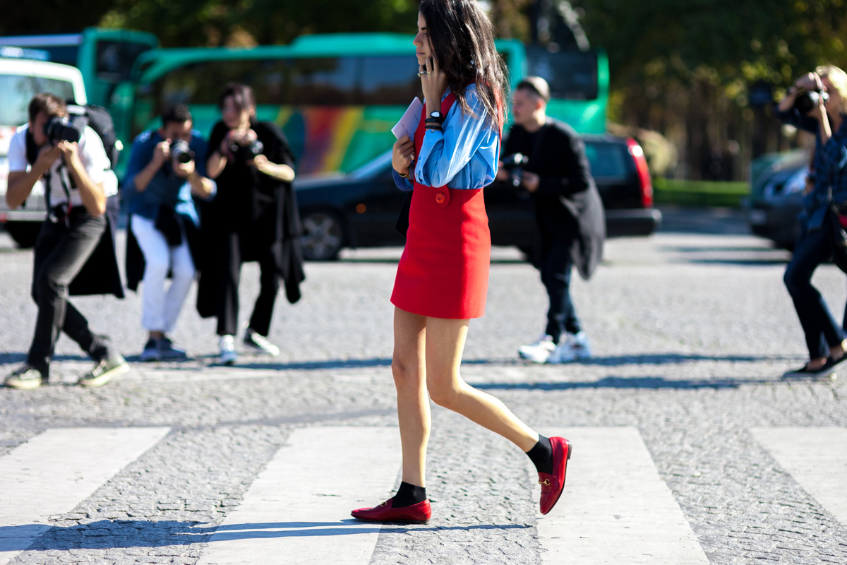 Leandra Medine wearing red jumper and Gucci loafers at Paris Fashion Week
