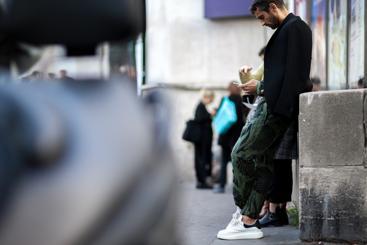 Simone Marchetti looking at his phone before the Rick Owens fashion show in Paris, France