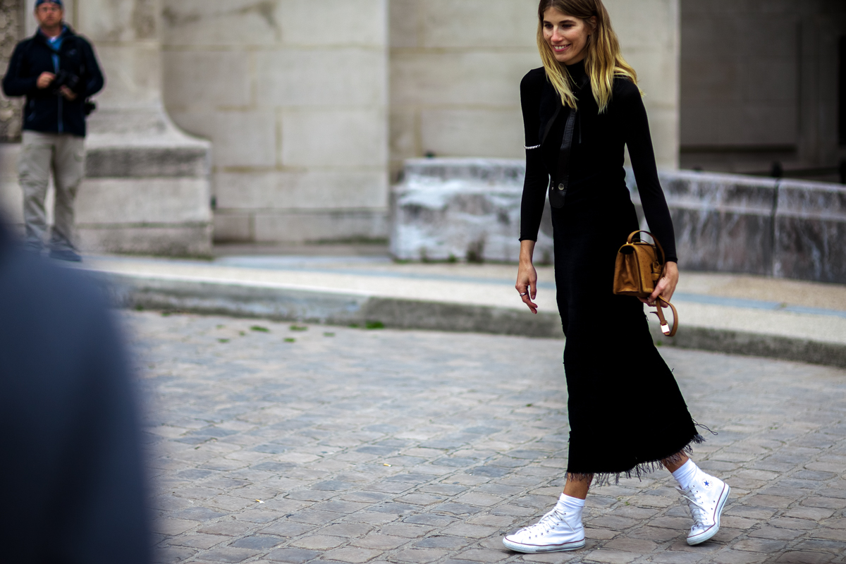 Veronika Heilbrunner wearing a black long dress and Converse shoes before a show at Paris Fashion Week