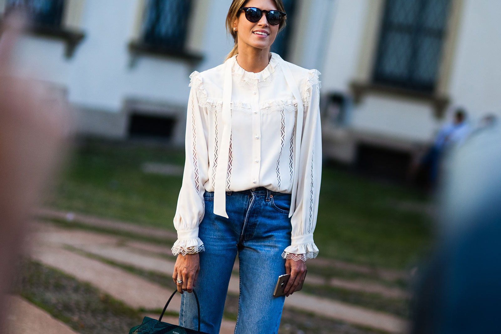 Woman wearing white blouse and Levis jeans at Milan Fashion Week