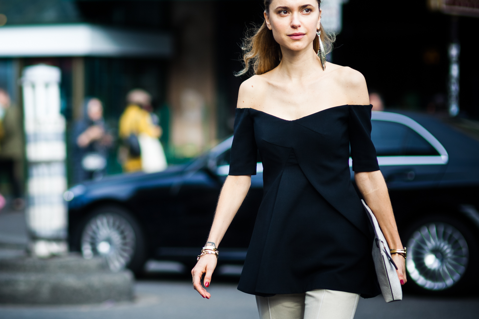 Danish stylist Pernille Teisbaek wearing a black top and a gold fish earring before the Stella McCartney fashion show in Paris, France