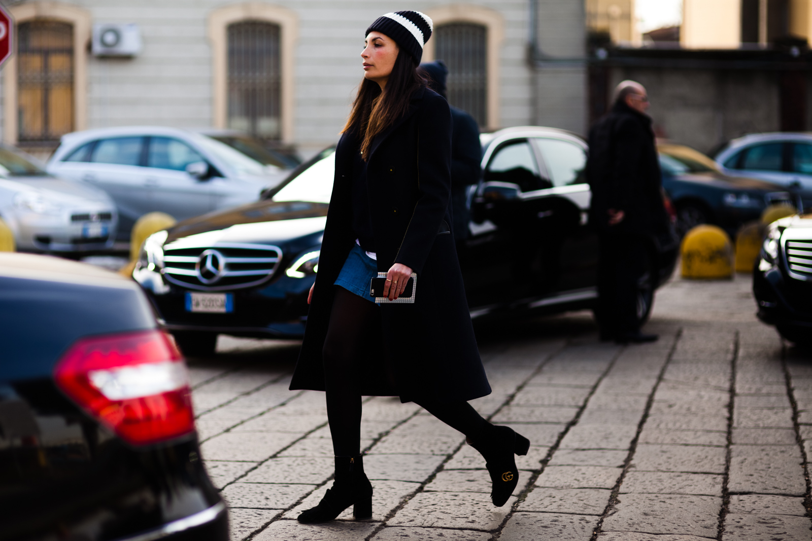 Laetitia Paul wearing a navy coat and black Gucci ankle boots before the Gucci Men's fashion show in Milan, Italy