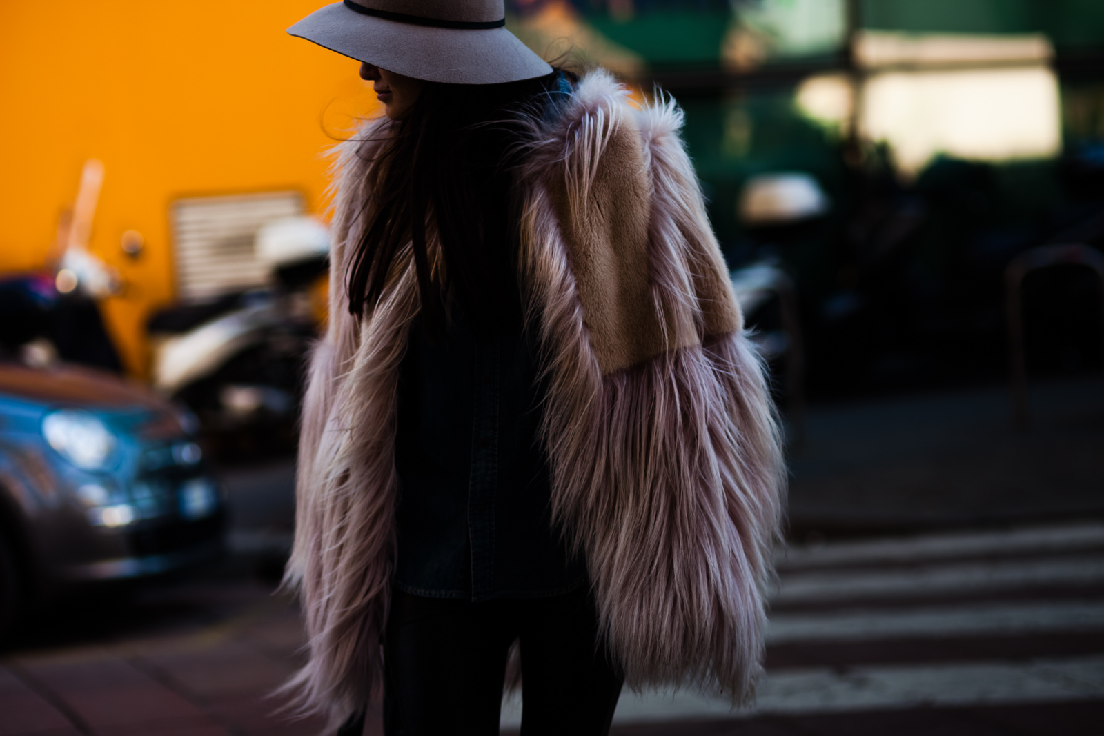 Woman wearing a fur jacket and a hat before the Giorgio Armani fashion show in Milan, Italy