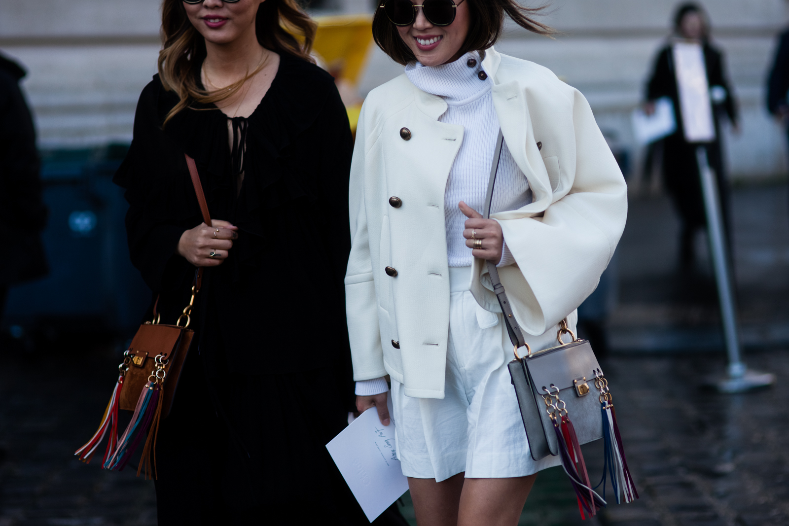 Aimee Song + Dani Song wearing Chloe outfits and fringed bags before the Chloe Fall/Winter 2016-2017 fashion show in Paris, France