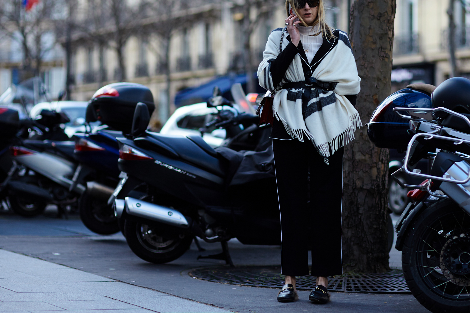 Fashion blogger Camille Charrière wearing a Mango suit and Gucci fur slippers before a fashion show in Paris, France