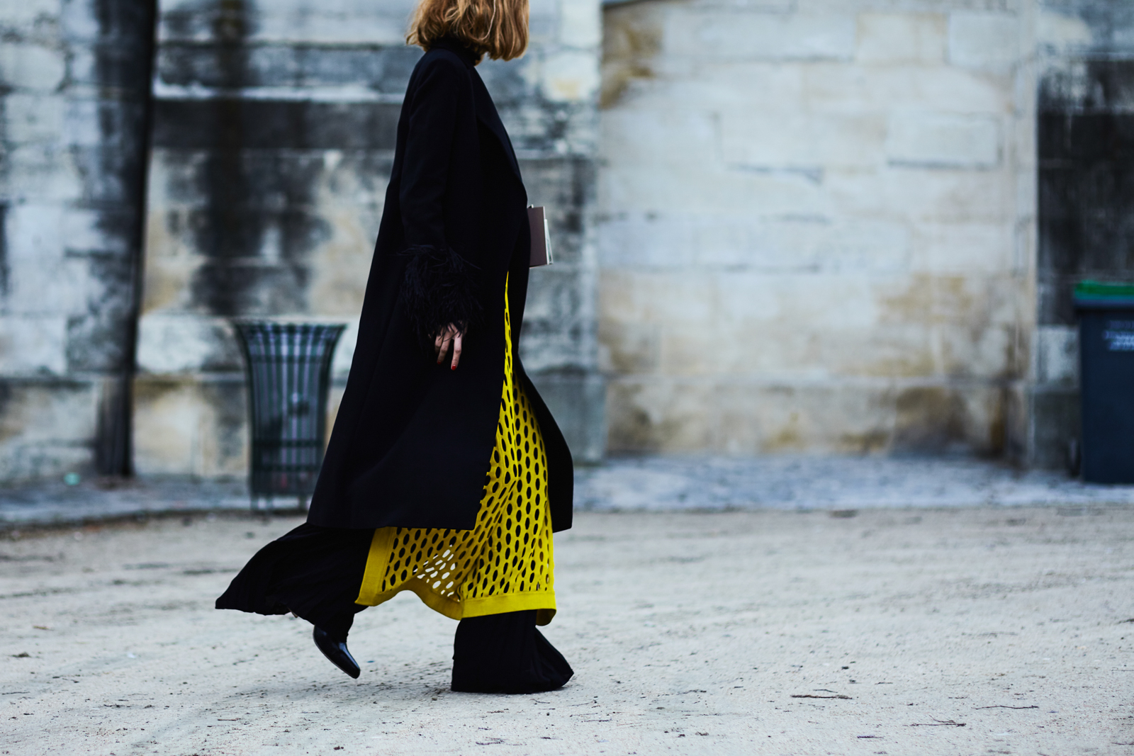Candela Novembre wearing a yellow top and black long coat before the Valentino Fall/Winter 2016-2017 fashion show in Paris, France