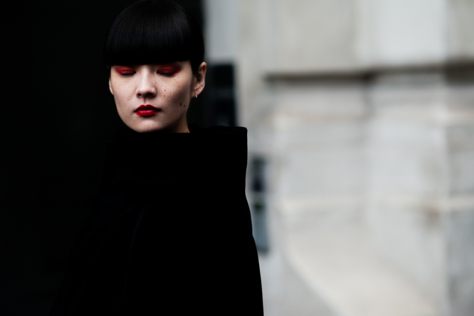 Kozue Akimoto wearing a black outfit and red make up before a fashion show in Paris, France