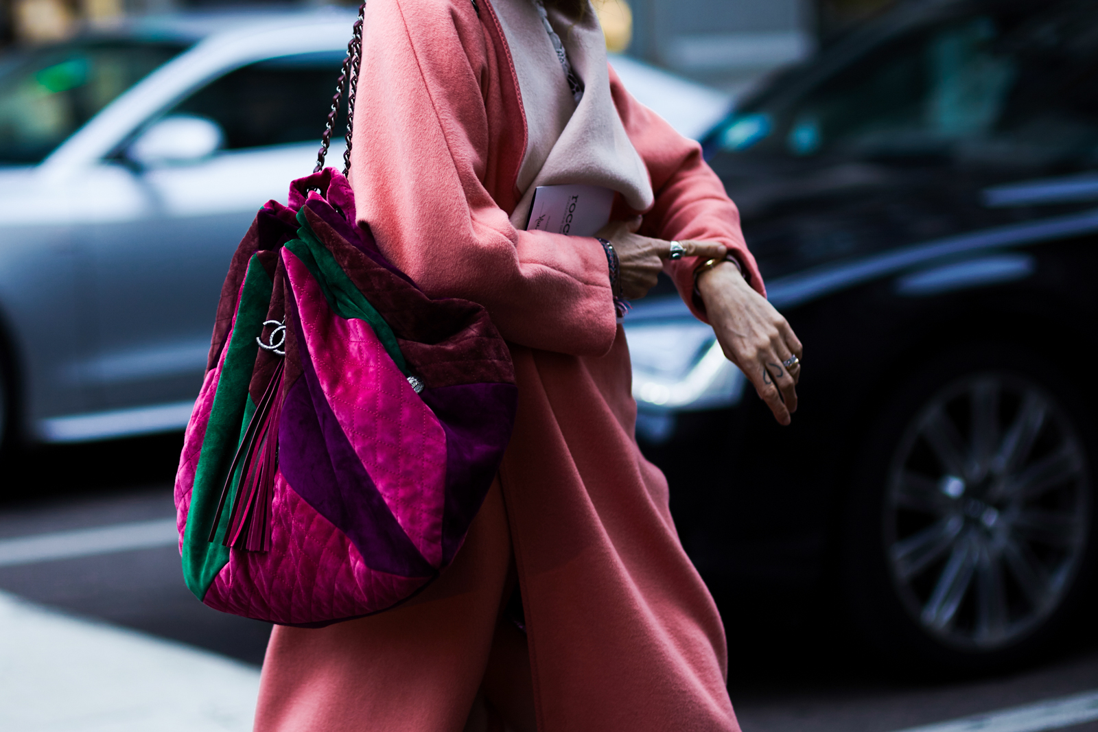 MFW Street Style: A woman wearing a pink coat and a multicolored Chanel bag before the Max Mara Fall 2016 fashion show in Milan, Italy