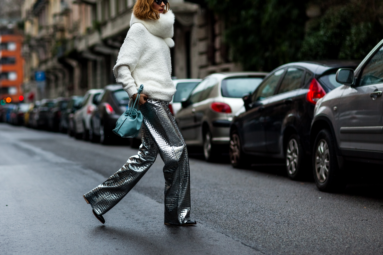 Candela Novembre wearing a white sweater and Loewe metallic leather pants before a show in Milan, Italy