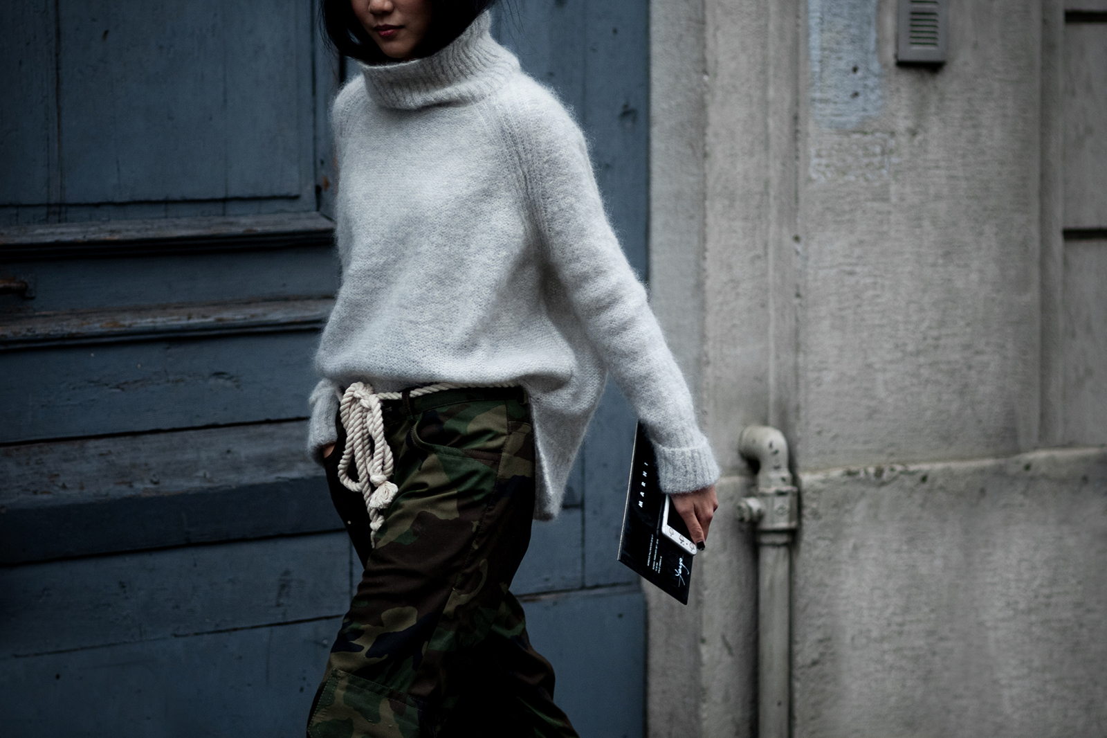 Yoyo Cao wearing a grey sweater and camo pants after the Marni Fashion Show in Milan, Italy