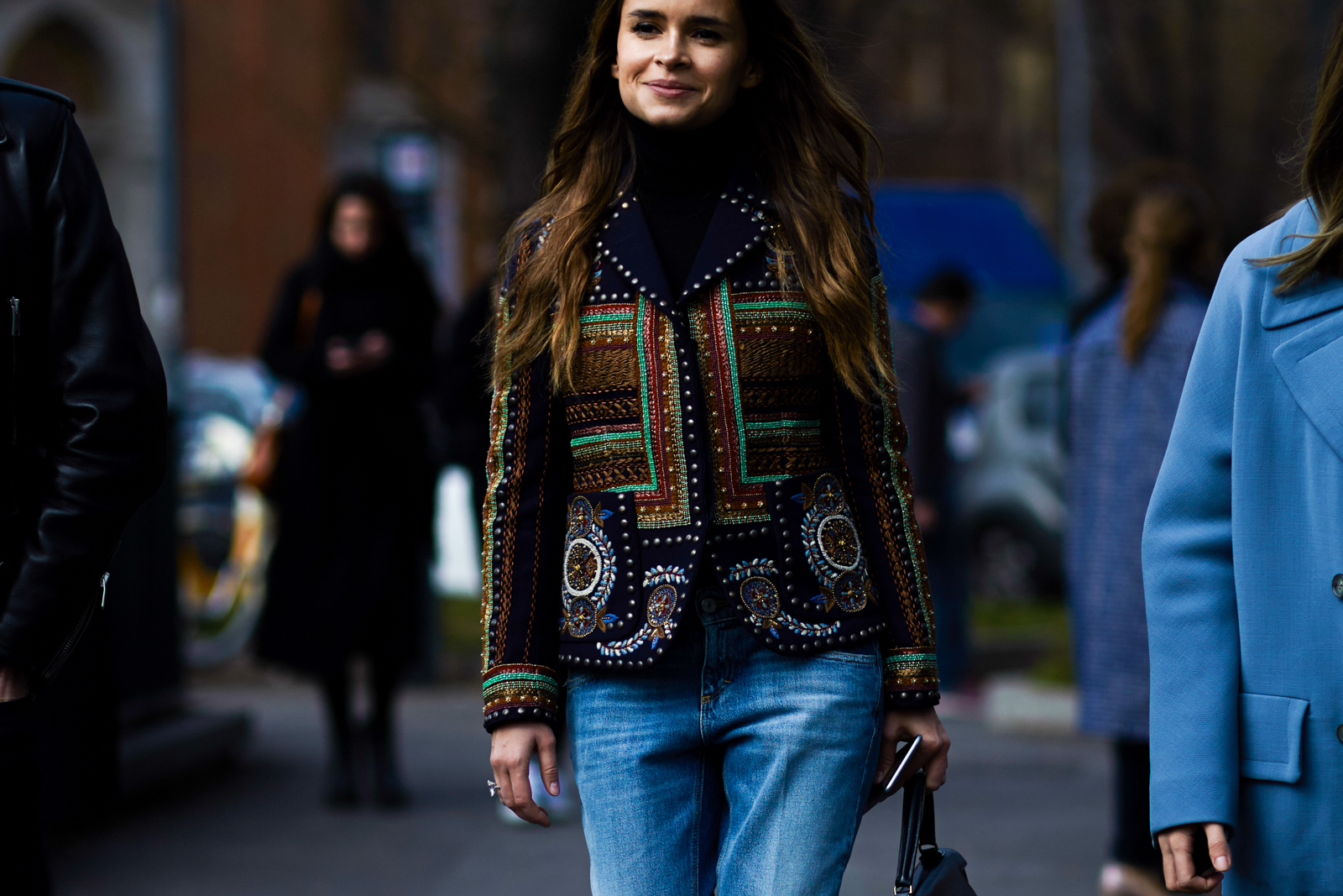 MFW Street Style: Miroslava Duma wearing a blue embroidered jacket by Valentino and jeans before a fashion show in Milan, Italy 