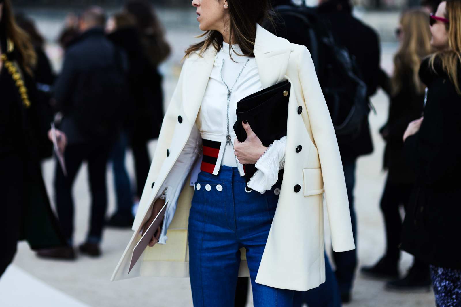 A woman wearing a white coat and jeans before the Valentino Fall/Winter 2016-2017 fashion show in Paris, France