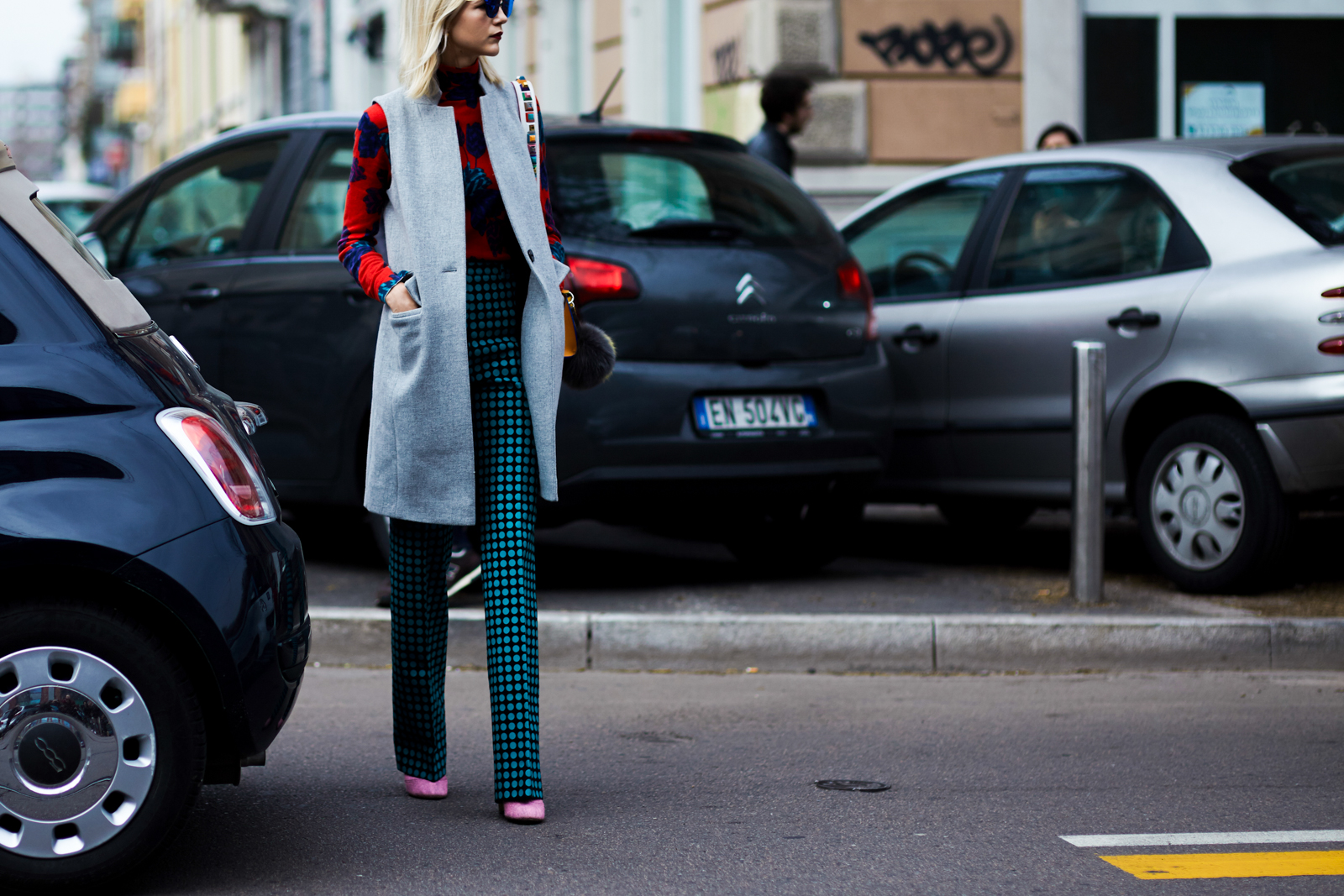 MFW Street Style: Samantha Angelo wearing a grey coat, printed pants, pink Chanel boots and Fendi bag before a fashion show in Milan, Italy
