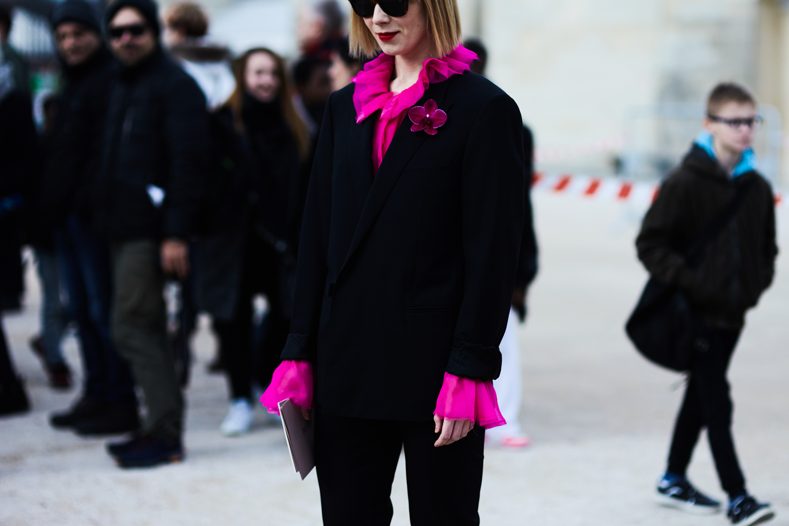 Designer Vika Gazinskaya wearing a black suit and a fuchsia blouse before the Valentino Fall/Winter 2016-2017 fashion show in Paris, France 