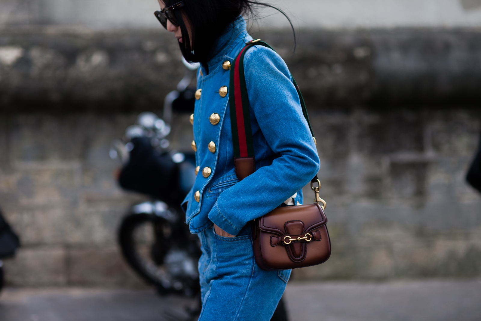 Yoyo Cao wearing a Gucci denim jacket and Gucci bag after a fashion show in Paris, France