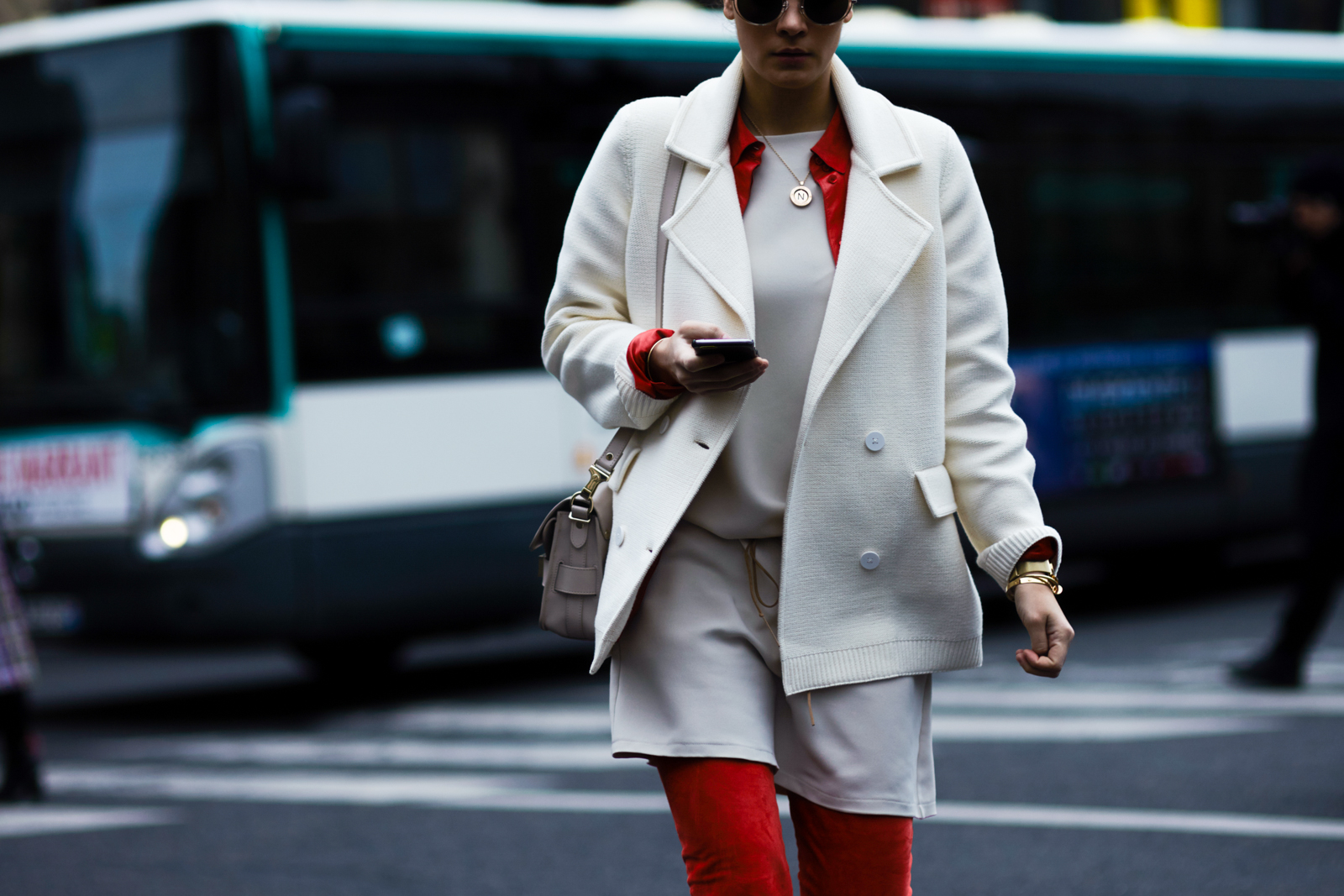 PFW Street Style: Fashion Blogger Nina Schwichtenberg wearing a white coat and red pants before the Stella McCartney Fall 2016 fashion show in Paris, France