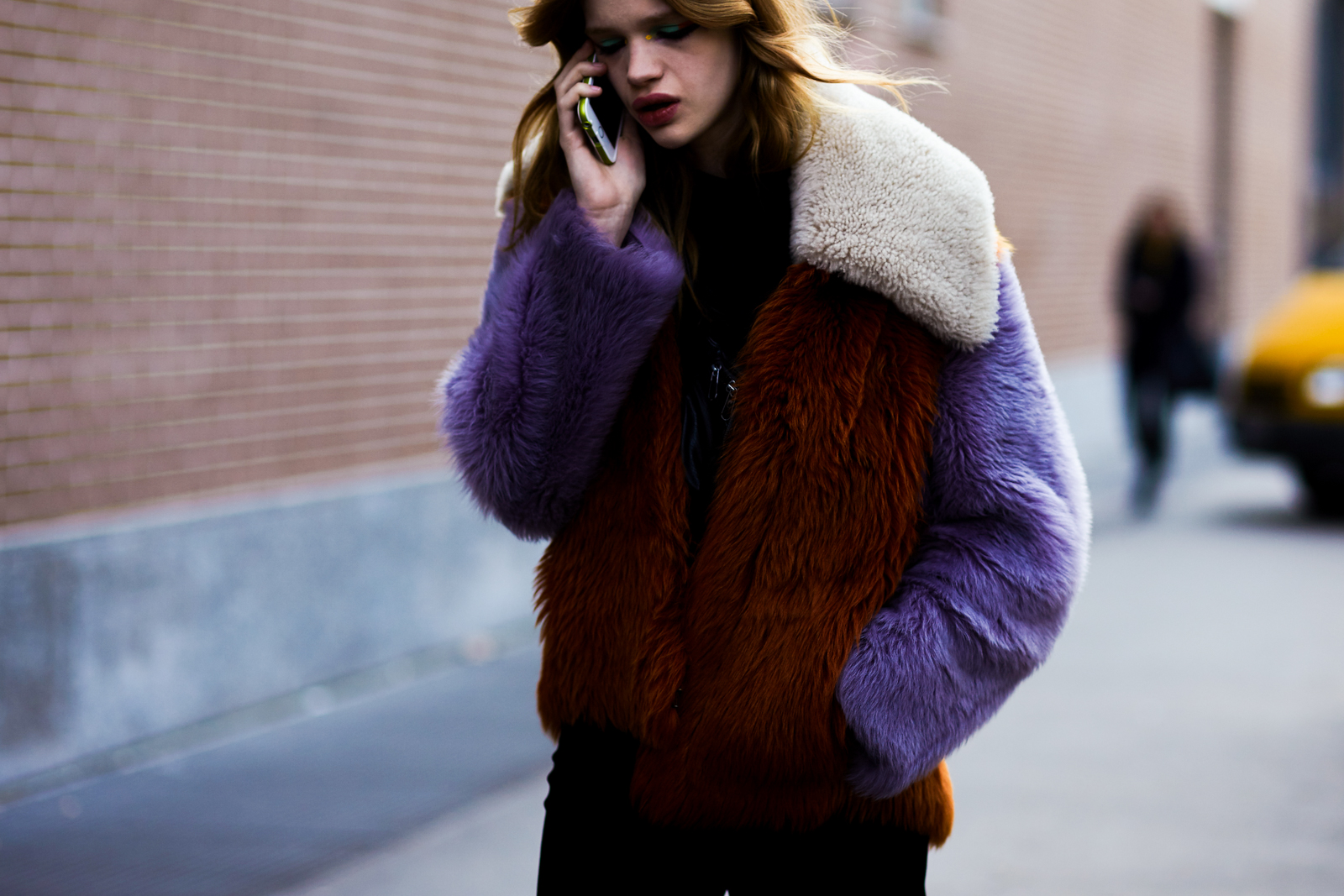 MFW Street Style: Model Stella Lucia wearing a color-blocked fur jacket and multicolored make up after the Fendi Fall 2016 fashion show in Milan, Italy