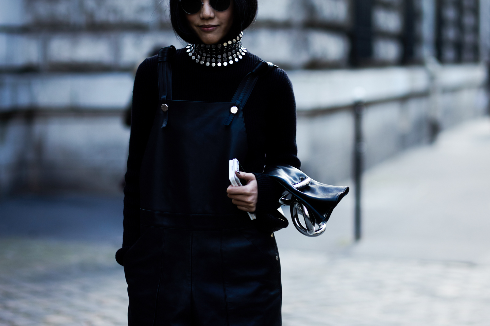 PFW Street Style: Yoyo Cao wearing a studded turtleneck by Alexander Wang, leather overalls and leather bag by J.W Anderson in Paris, France