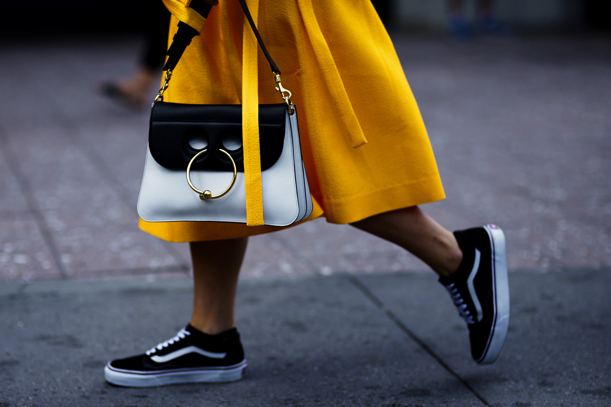Kate Foley wearing a yellow dress, Vans sneakers and J.W.Anderson bag after a fashion show in New York City, September 2016