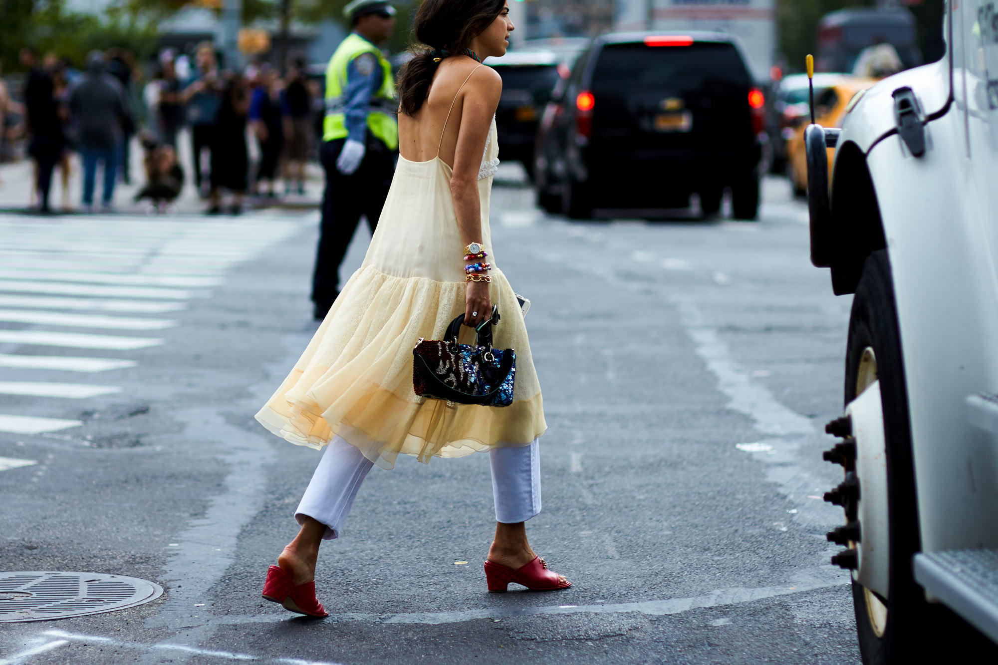 NYFW Spring-Summer 2017 Streetstyle: Leandra Medine of The Man Repeller wearing a dress over pants and red mules after a show in New York, September 2016