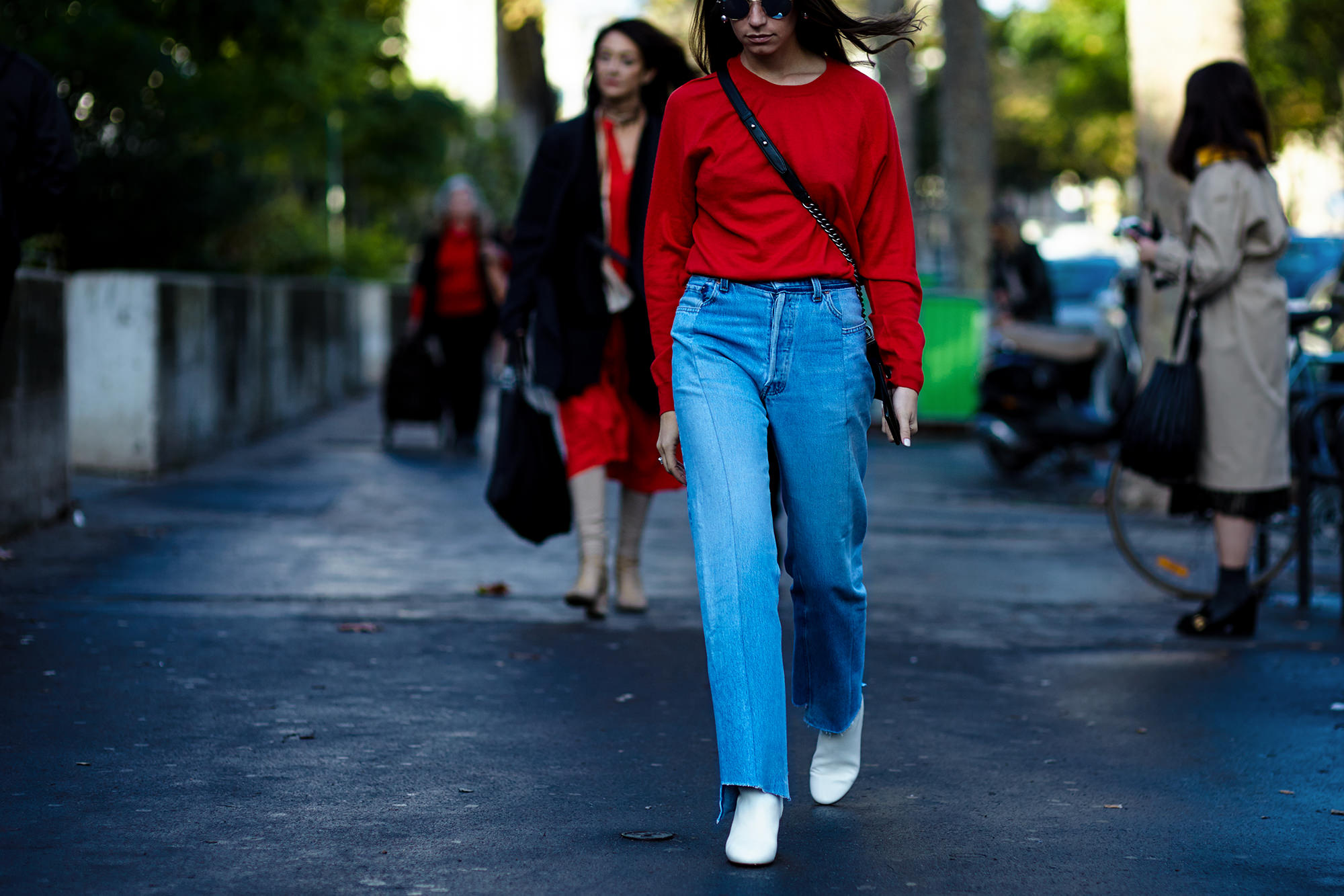PFW Spring-Summer 2017 street style: Amanda Alagem wearing a red sweater, Vetements jeans and white ankle boots before a show in Paris, France