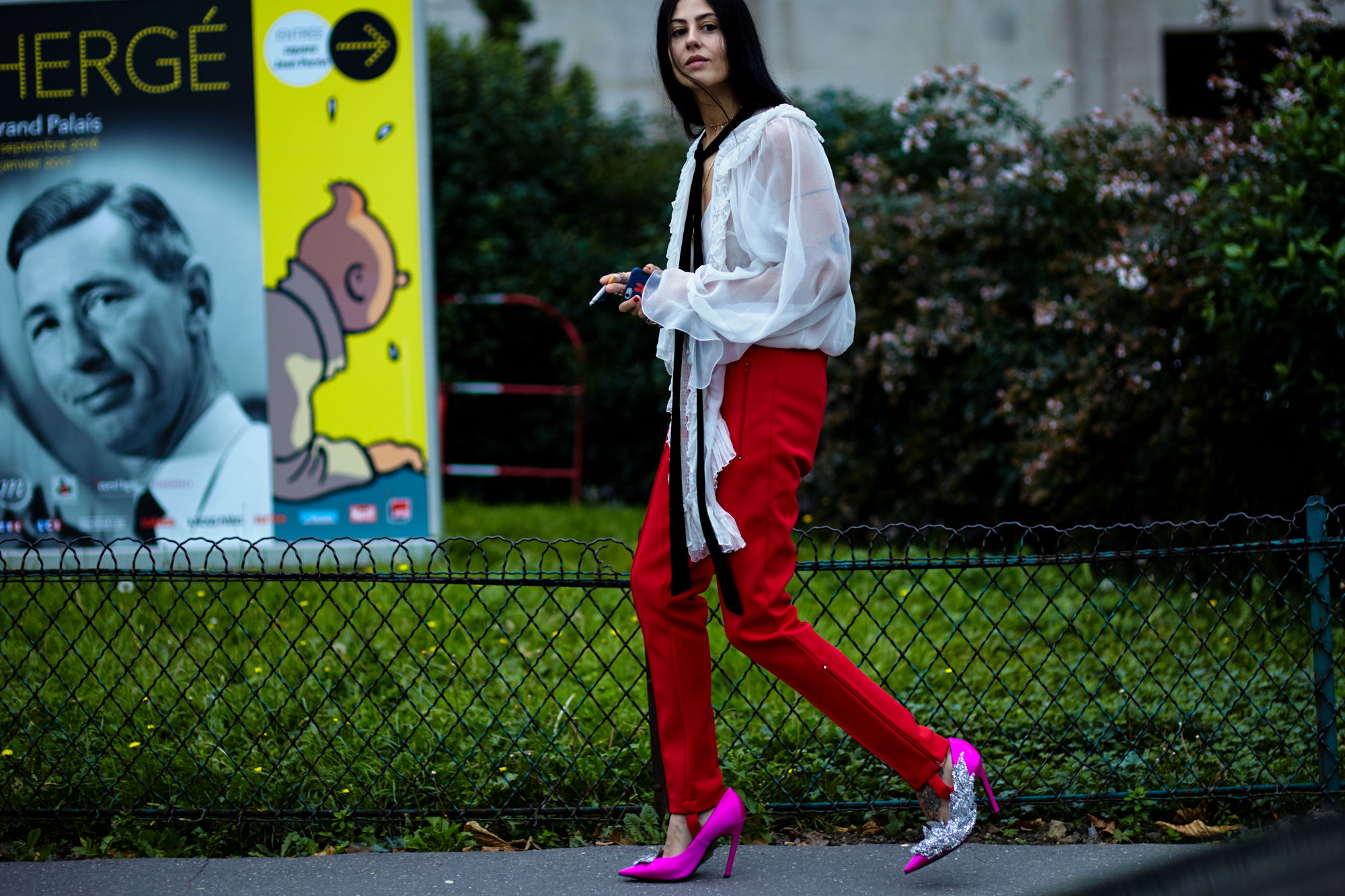 PFW Spring-Summer 2017 Street Style:Gilda Ambrosio wearing a white blouse, red pants and pink embellished pumps by Balenciaga in Paris, France