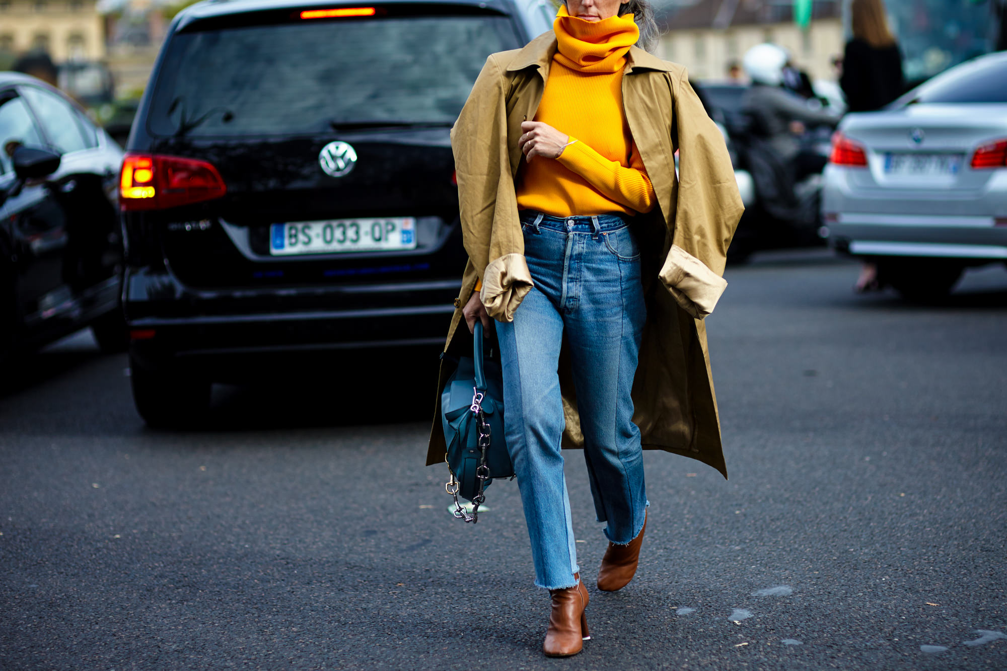 PFW Spring-Summer 2017 street style: Woman wearing Vetements coat, jeans and shoes and Loewe bag before the Loewe fashion show in Paris