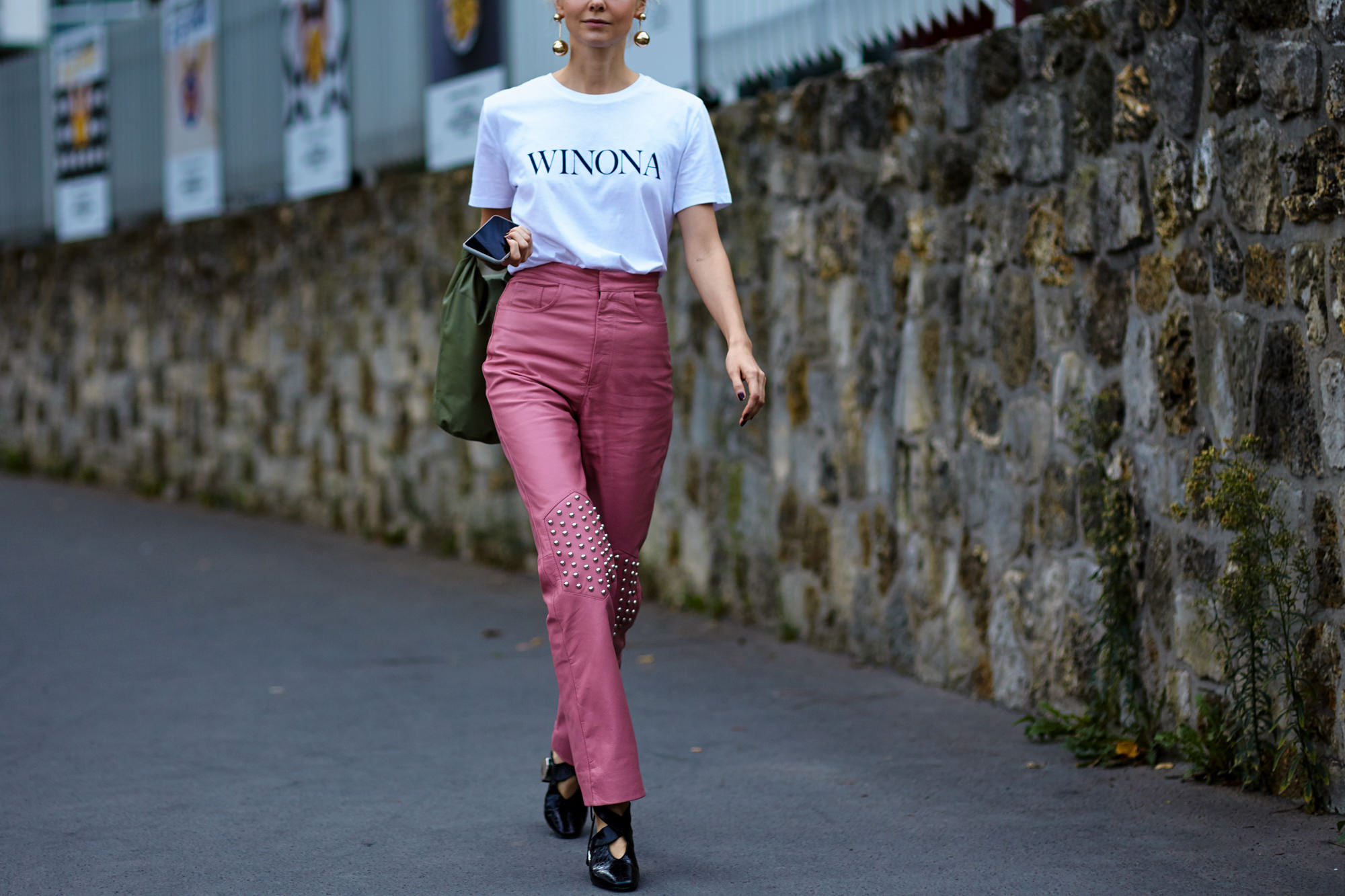 Olga Karput wearing pink leather pants and white tee after the Loewe fashion show in Paris