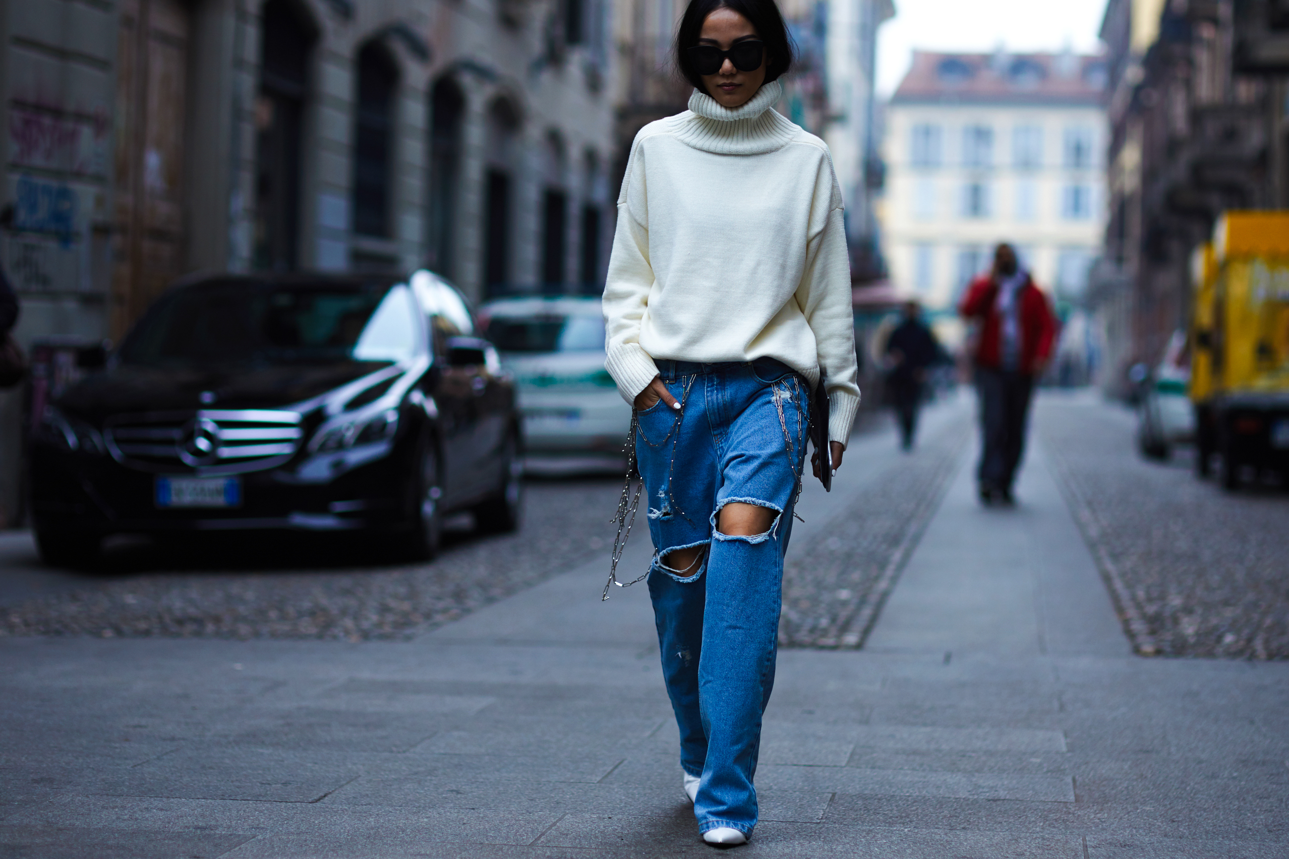 Yoyo Cao wearing baggy jeans and white turtleneck sweater before a show in Milan, Italy