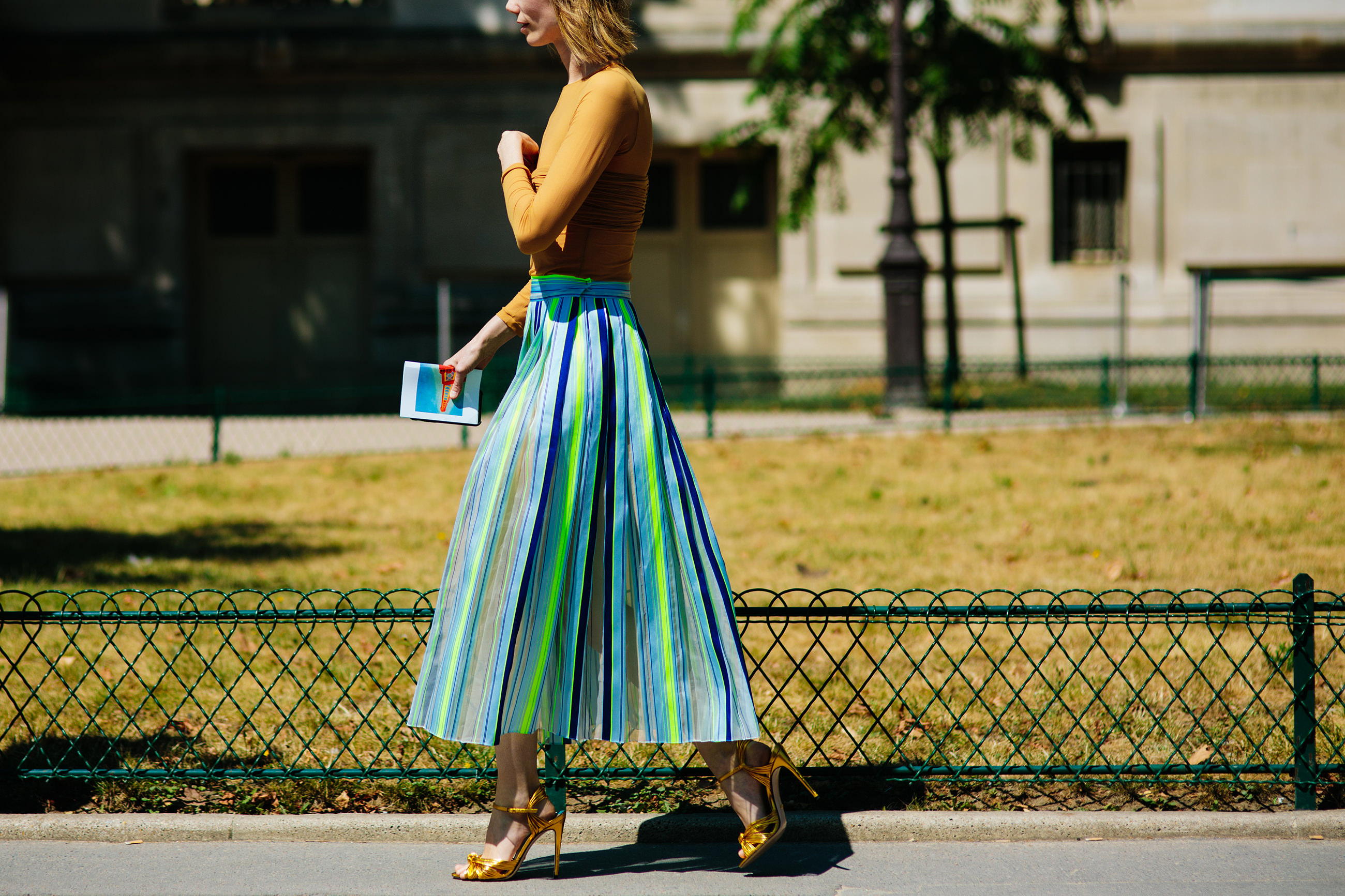Anya Ziourova wearing a pleated skirt and top by Vika Gazinskaya and Gucci heels before the Chanel HC fashion show in Paris, France