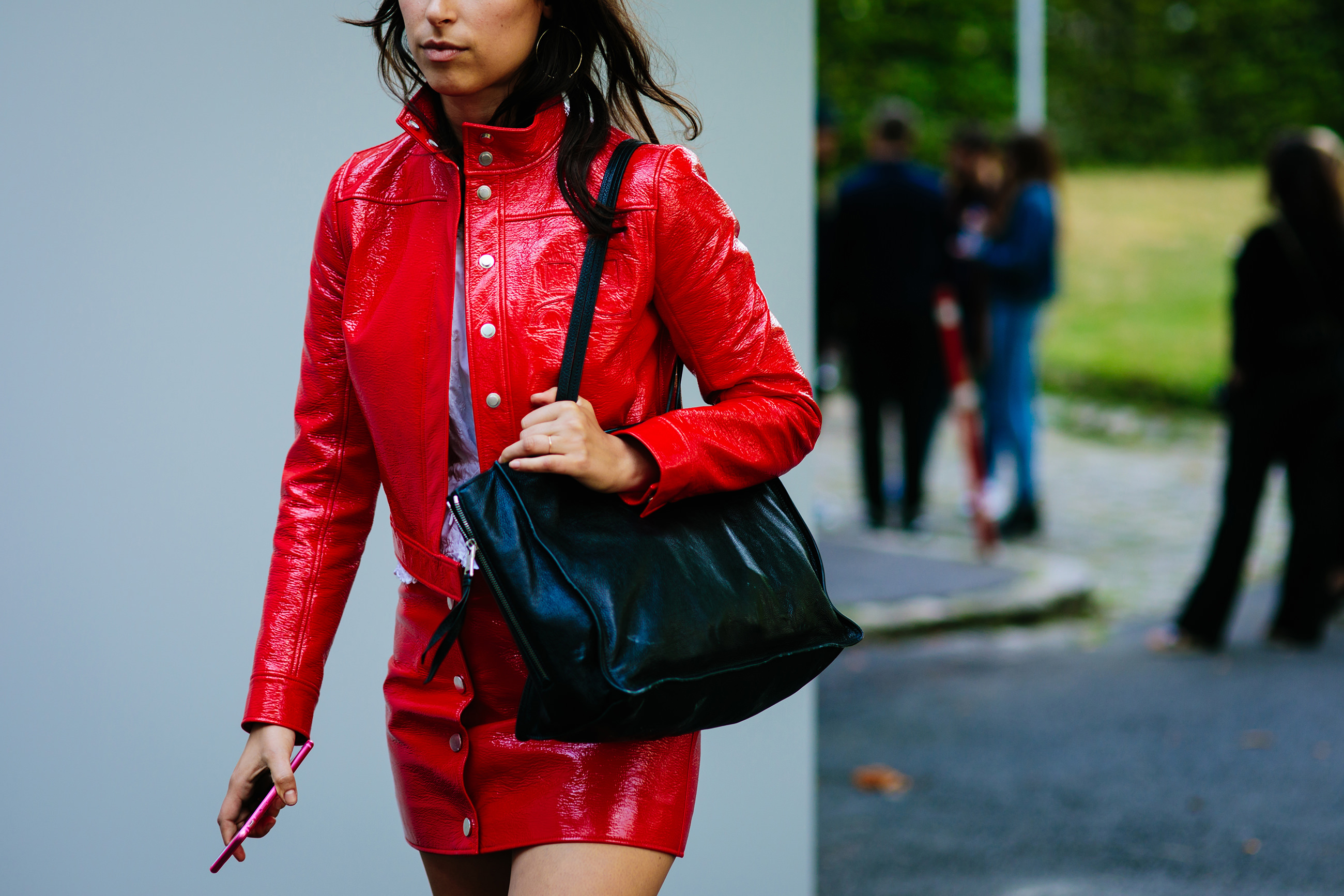 Woman wearing a Courreges red patent outfit after the Rodarte SS18 fashion show in Paris, France