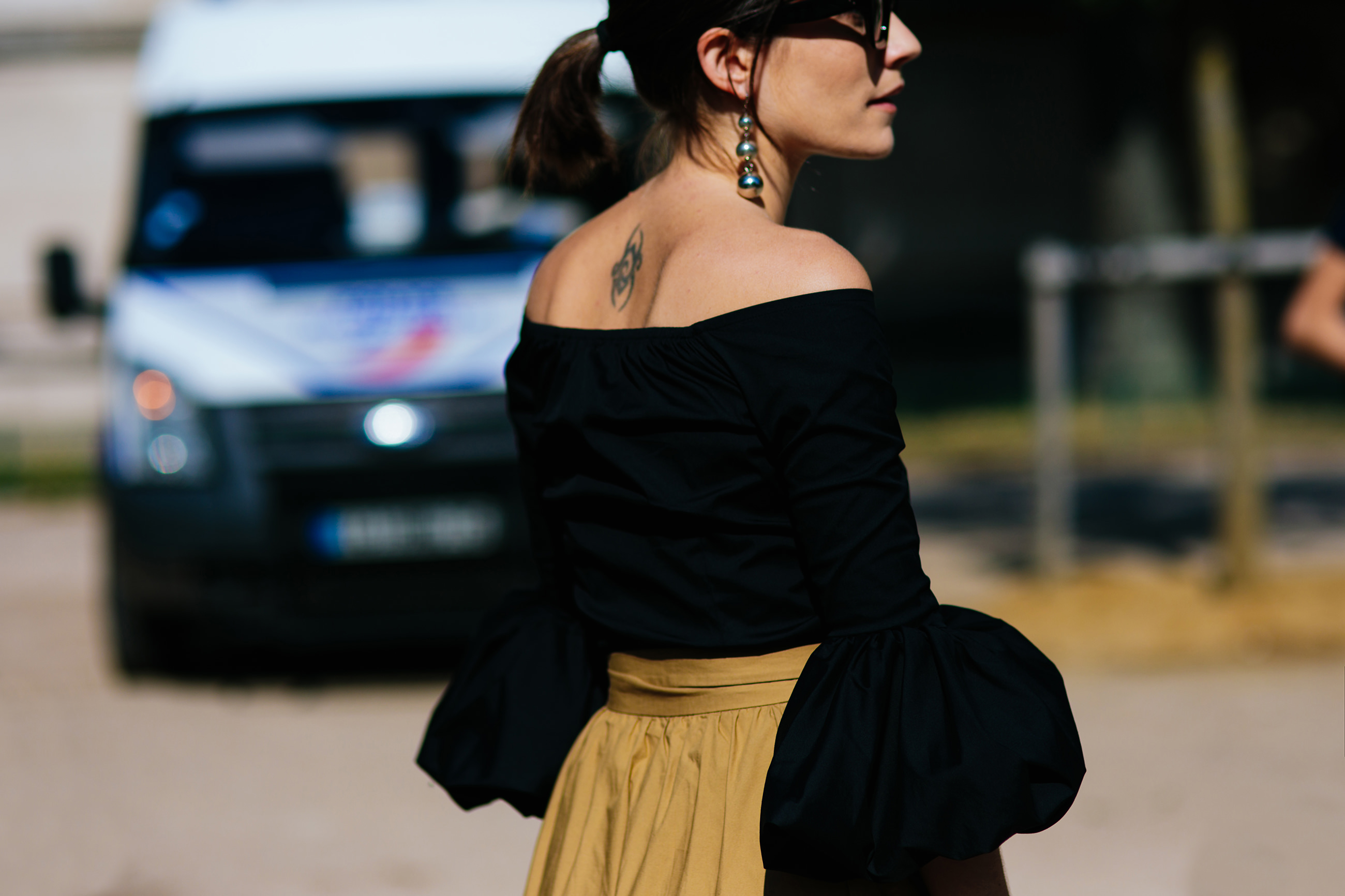 Blogger Carola Pojer wearing a black top and brown ruffled skirt before Chanel Haute Couture fashion show in Paris, France