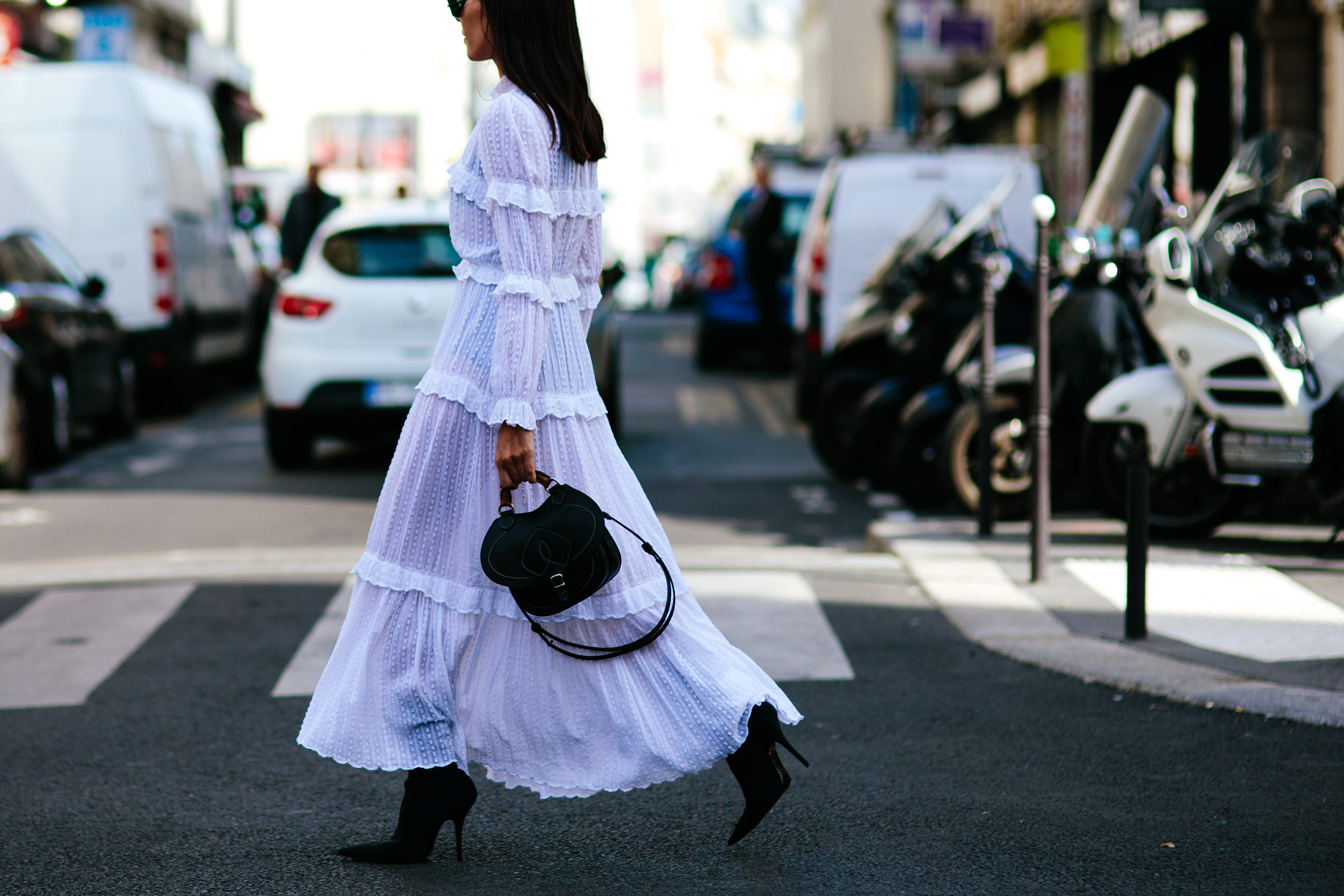 Fashion Blogger Evangelie Smyrniotaki wearing a long white Isabel Marant dress, Balenciaga boots and Margiela bag before the Margiela Couture fashion show in Paris, France