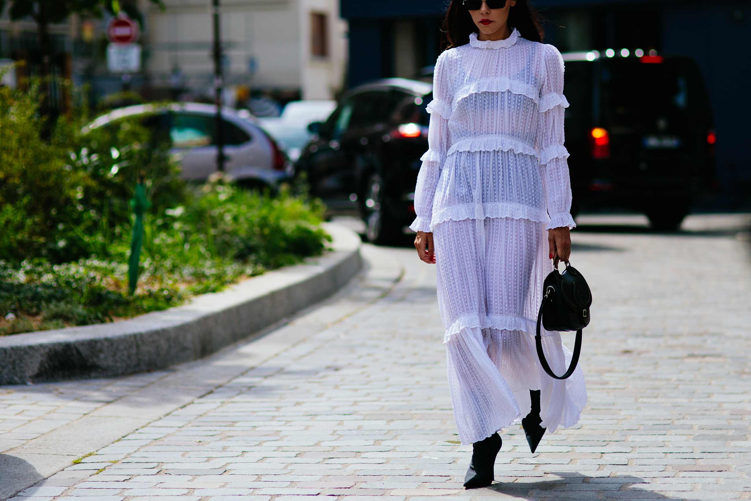 Fashion Blogger Evangelie Smyrniotaki wearing a long white Isabel Marant dress, Balenciaga boots and Margiela bag before the Margiela Couture fashion show in Paris, France