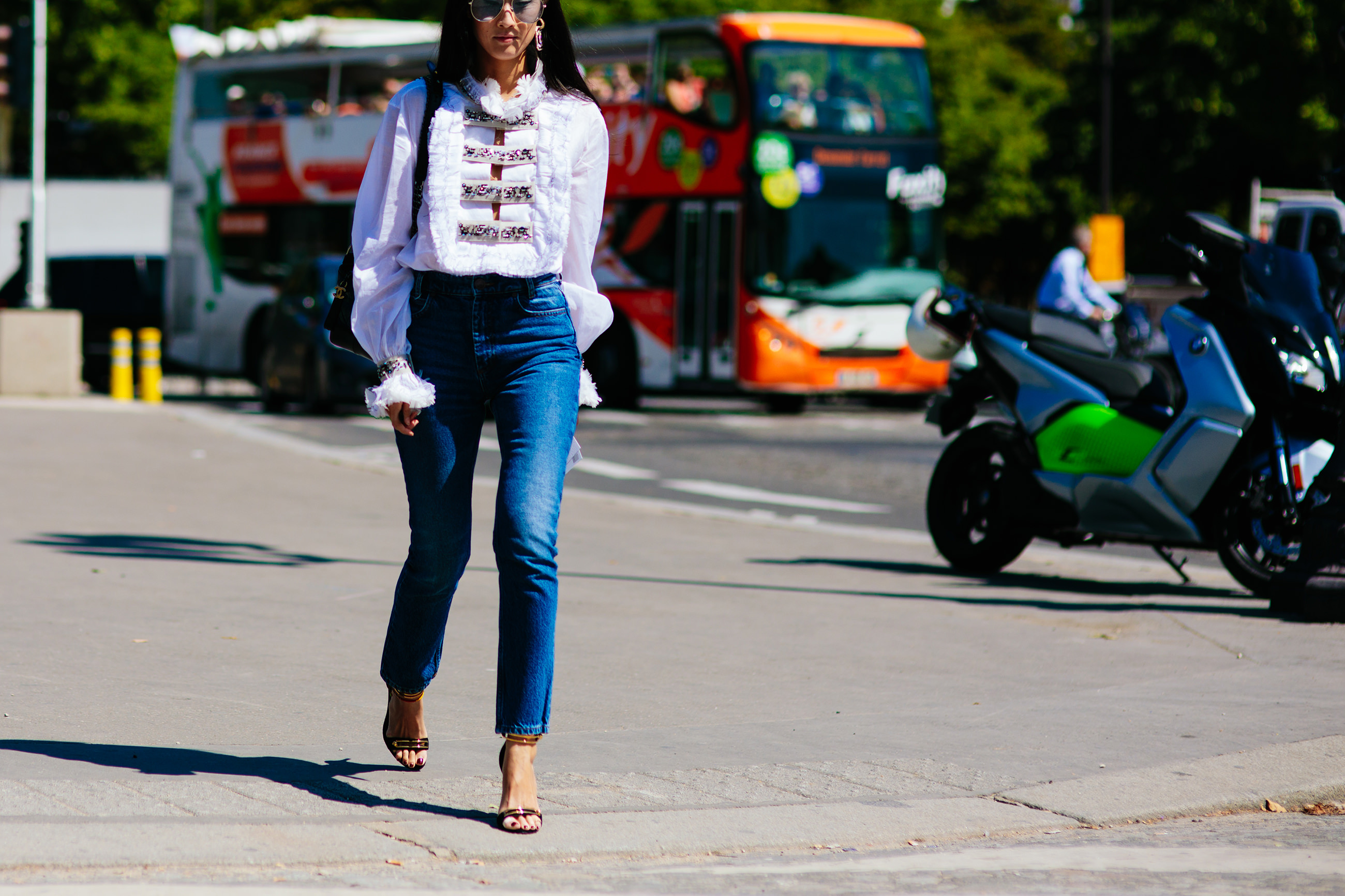 Justine Lee wearing a white Chanel blouse and skinny jeans in Paris, France